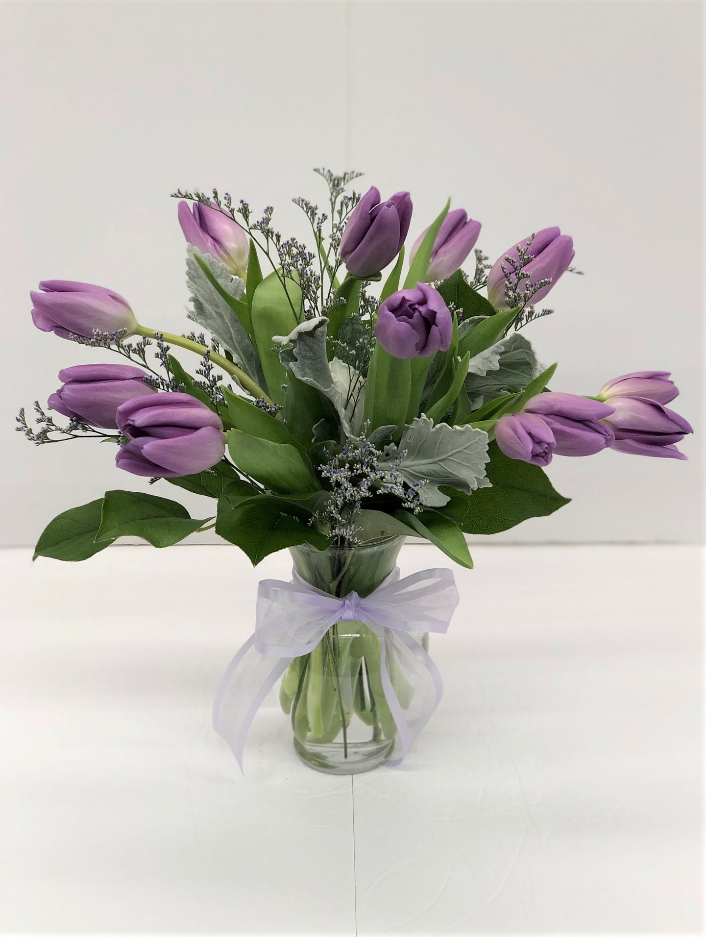Lavendar Tulips - LOCAL DELIVERY ONLY; Local delivery is limited to Austell, Mableton, Marietta, Smyrna and Vinings.  Fresh tulips, beautifully and artfully arranged by one of our talented designers. Filler flowers and greenery may vary.  10 STEMS AS SHOWN  