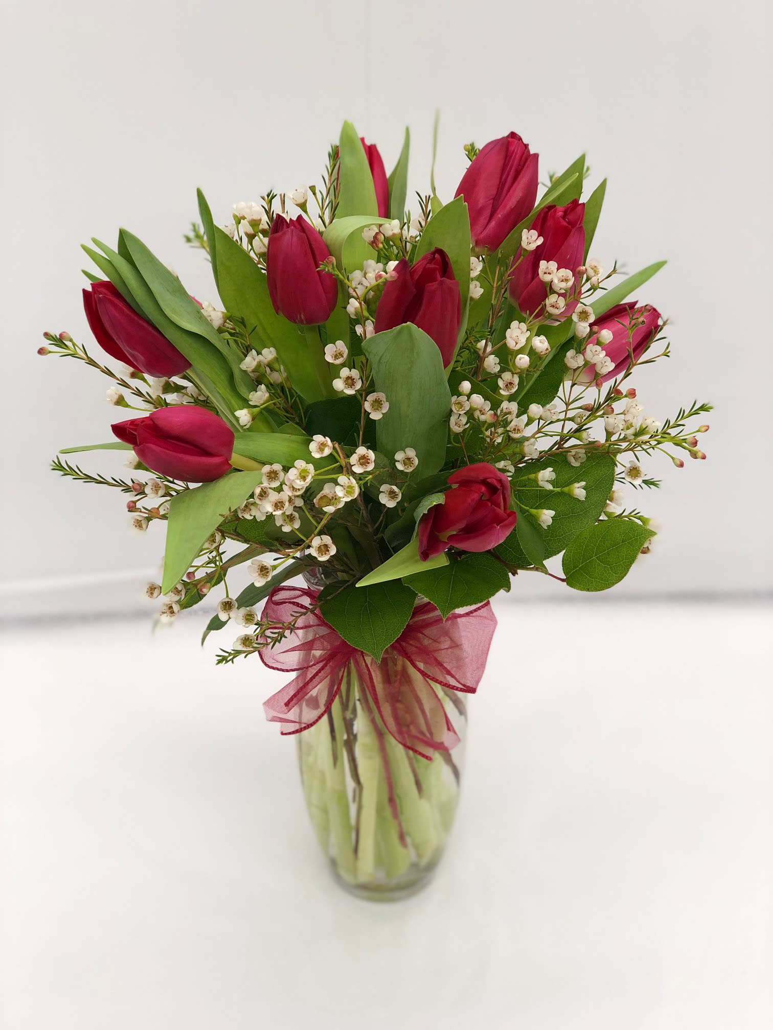 Red Tulips - Local Delivery Only - LOCAL DELIVERY ONLY; Local delivery is limited to Austell, Mableton, Marietta and Smyrna.  Fresh tulips, beautifully and artfully arranged by one of our talented designers. Filler flowers and greenery may vary.  10 STEMS AS SHOWN  