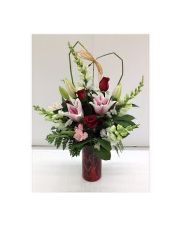 Romantic Duo Bouquet - Perfect combination for the perfect duo! Give this arrangement to your other half and look at their expression. A beautiful arrangement of pinks, reds and whites arranged by our designers in our red hearts vase.   Vase may be substituted depending on availability, flowers and colors may vary.   FCF-VDRD