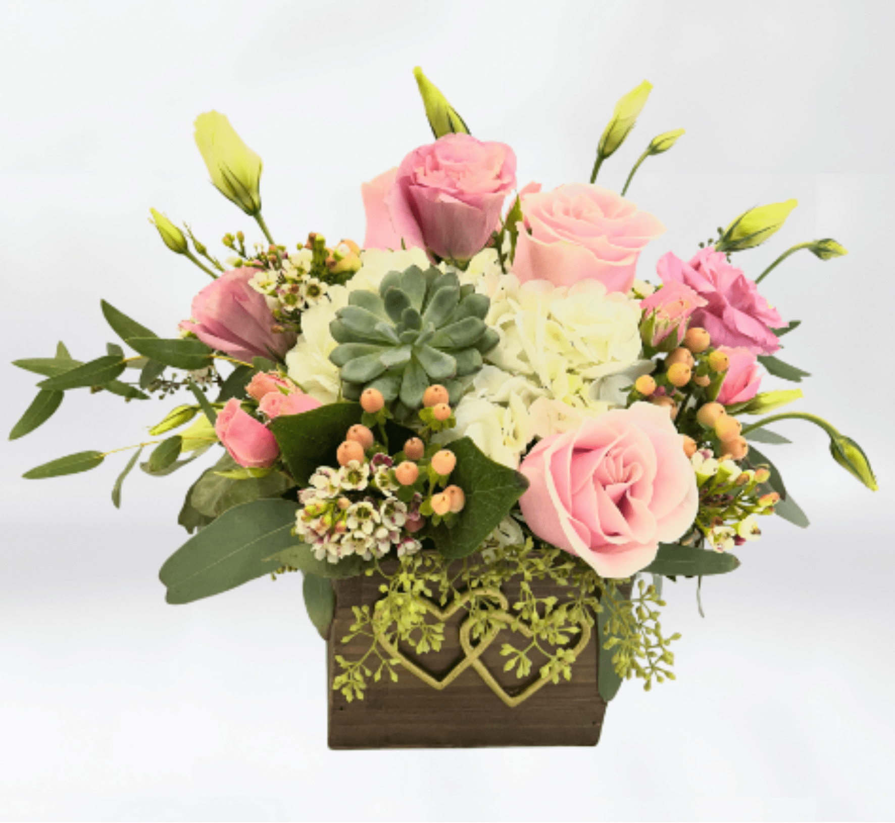 Our Hearts - Our Hearts Floral Arrangement   A timeless expression of love and romance—perfect for Valentine’s Day and meaningful moments year-round. Designed in a charming wooden container, this elegant arrangement features soft light pink roses, lush white hydrangeas, and delicate lisianthus, beautifully accented with hypericum berries, airy wax flower, and fragrant seeded eucalyptus.  Ideal for Valentine’s Day flowers, anniversaries, weddings, or heartfelt sympathy gifts, Our Hearts showcases gentle pastel tones and rich textures that convey warmth, love, and comfort. The natural wooden container adds a rustic yet refined touch, making this arrangement a stunning centerpiece for any space.  Handcrafted with premium fresh blooms, the Our Hearts arrangement is a beautiful way to say “I love you.” Available for Valentine’s Day flower delivery, same-day delivery, and special occasions.