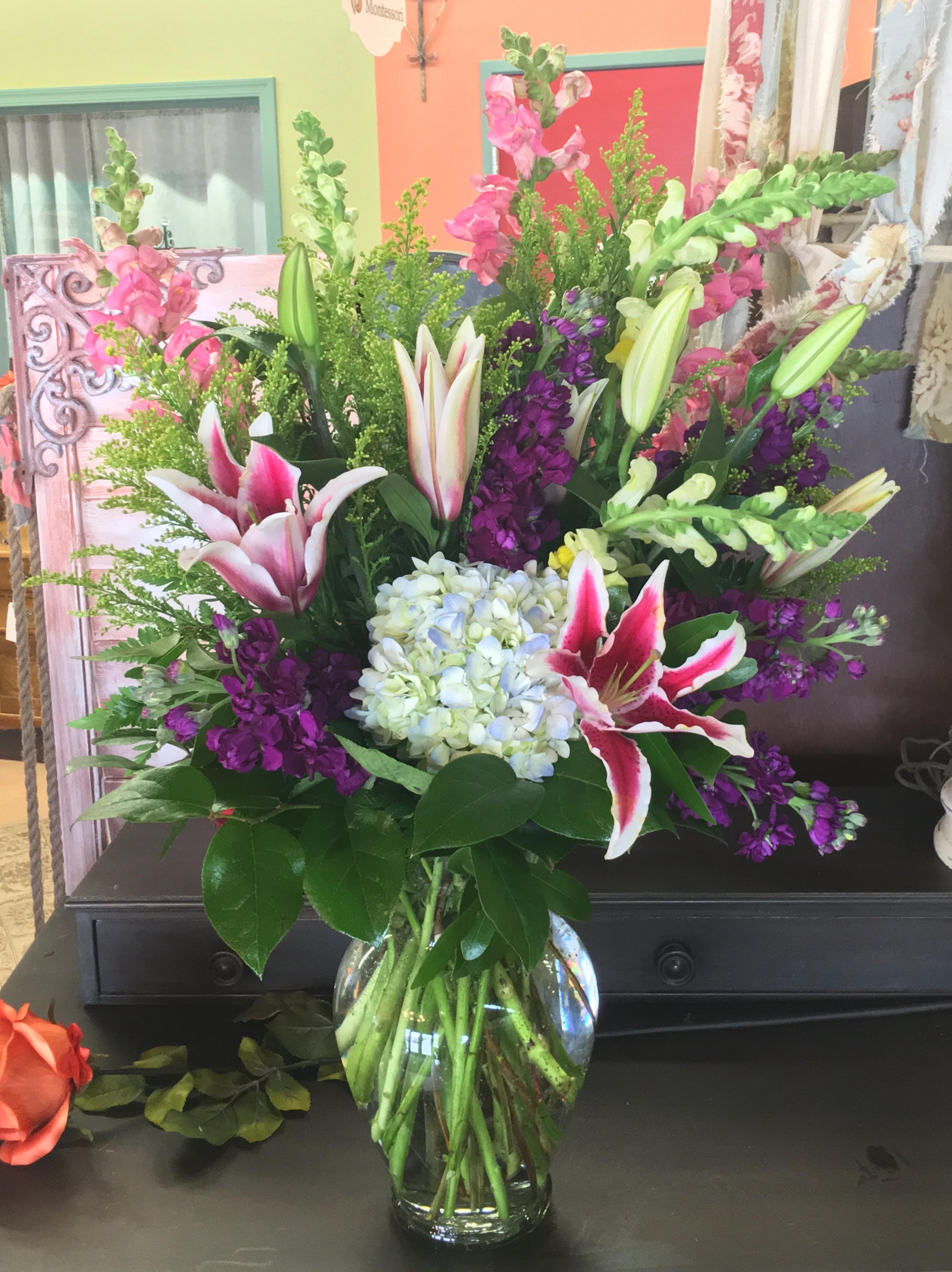 Love Everlasting Bouquet - Let the family at home know you are thinking of them with this lovely bouquet of stargazer lilies, hydrangea and fragrant stock flower. It will mean a lot. The stunning bouquet includes hydrangea stargazer lilies pink and purple stock accented with assorted greenery. Delivered in a clear glass vase. One-Sided As Shown