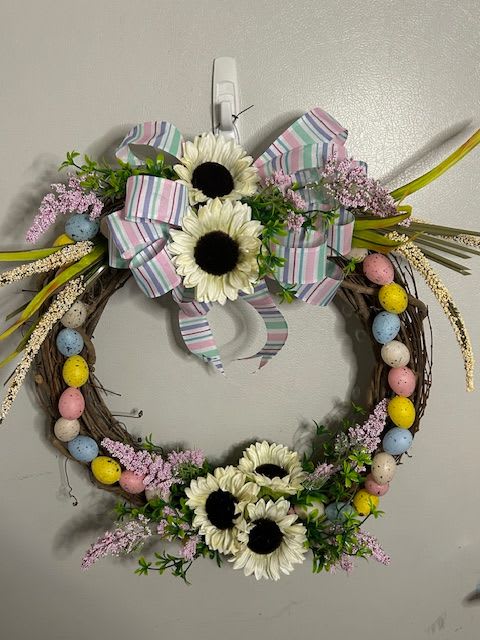 egg hunt wreath - An artificial wreath sporting white sunflowers and multicolored eggs perfect for spring or easter