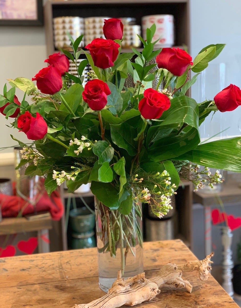 Willow's Finest Dozen - A timeless expression of love and beauty, this arrangement features a dozen deep red roses, complemented by delicate wax flowers for added charm.  Standard – Dozen Red Roses with Wax Flower Deluxe – Eighteen Red Roses   Perfect for anniversaries, romantic gestures, or any occasion that calls for a classic symbol of love.