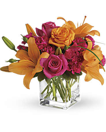 Uniquely Chic - Tres chic! Send that special someone a stylish sentiment with the bright colors of this modern arrangement. Summery hot pinks and oranges are contrasted by the cool clarity of a simple cube vase. An eye-catching everyday choice! Orange asiatic lilies, hot pink and light orange roses, miniature red carnations and a bit of understated greenery. Delivered in a clear glass cube vase. Orientation: All-Around