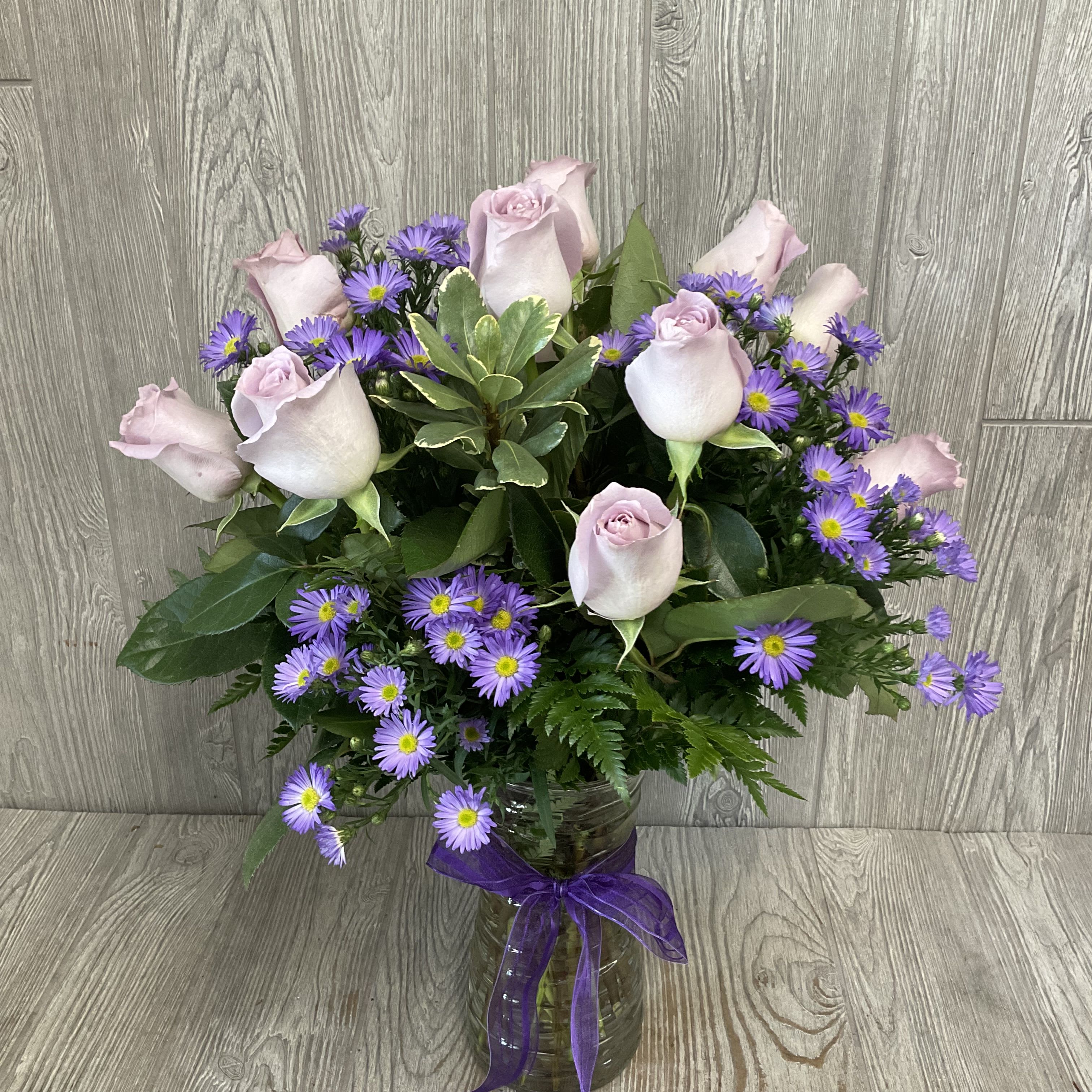 Lavender Roses - Beautiful lavender roses arranged in a vase. Standard is 12 roses, Deluxe is 18 roses, and Premium is 24 roses. Shade of lavender may vary. 