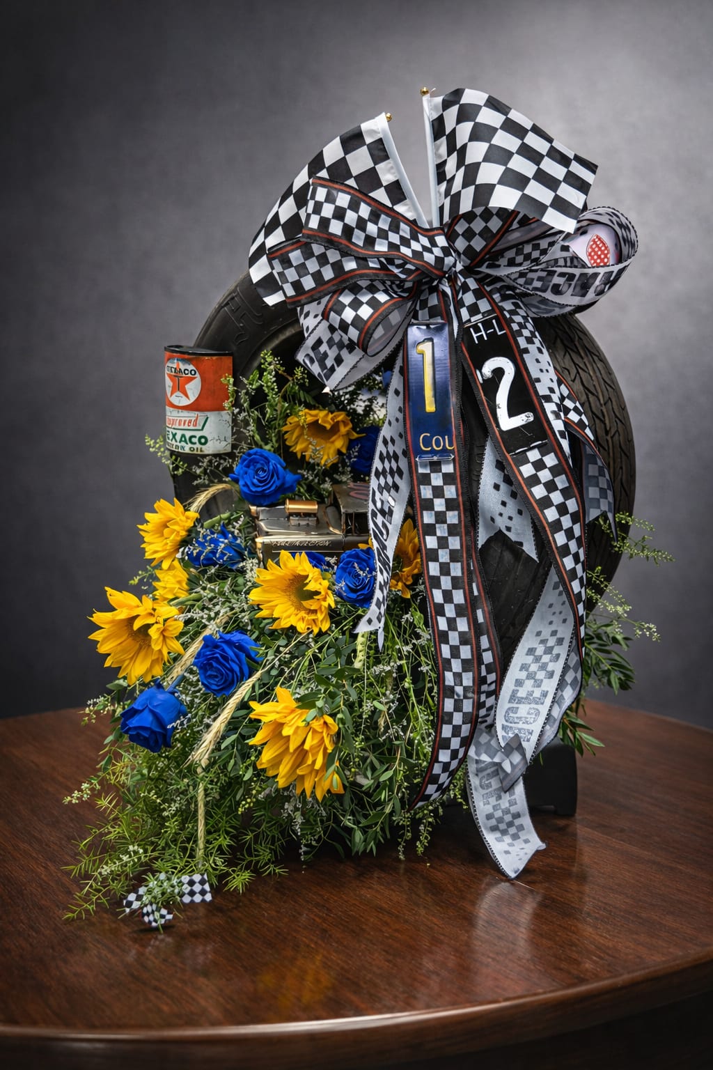 Last lap - Funeral arrangement inside racing tire. Flowers may vary