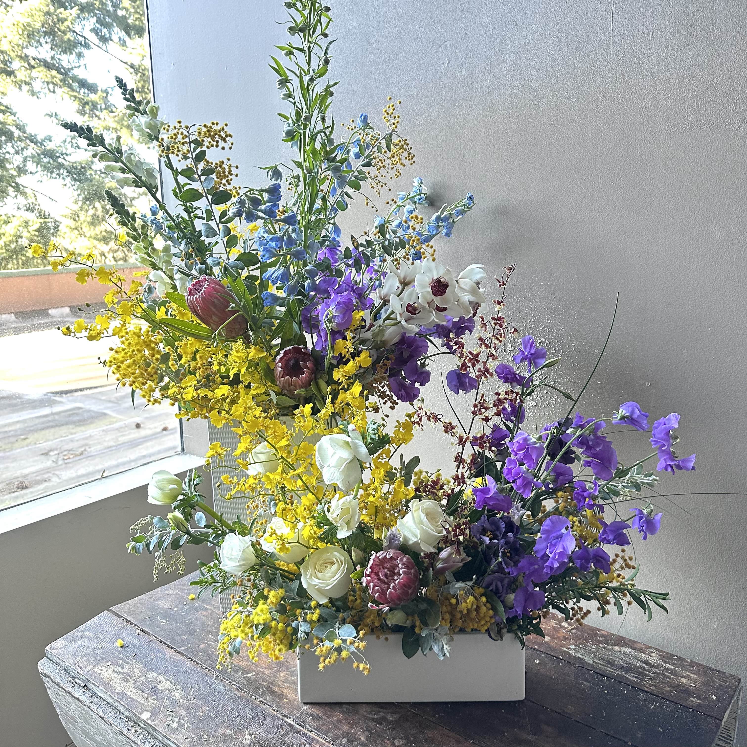 Jeju (Gallery Photo) - A perfectly paired, coordinated set designed to delight! Display them together for a stunning statement or style them separately to spread the joy. Overflowing with vibrant seasonal blooms, this beautiful duo sends a burst of color to brighten your loved one’s day.