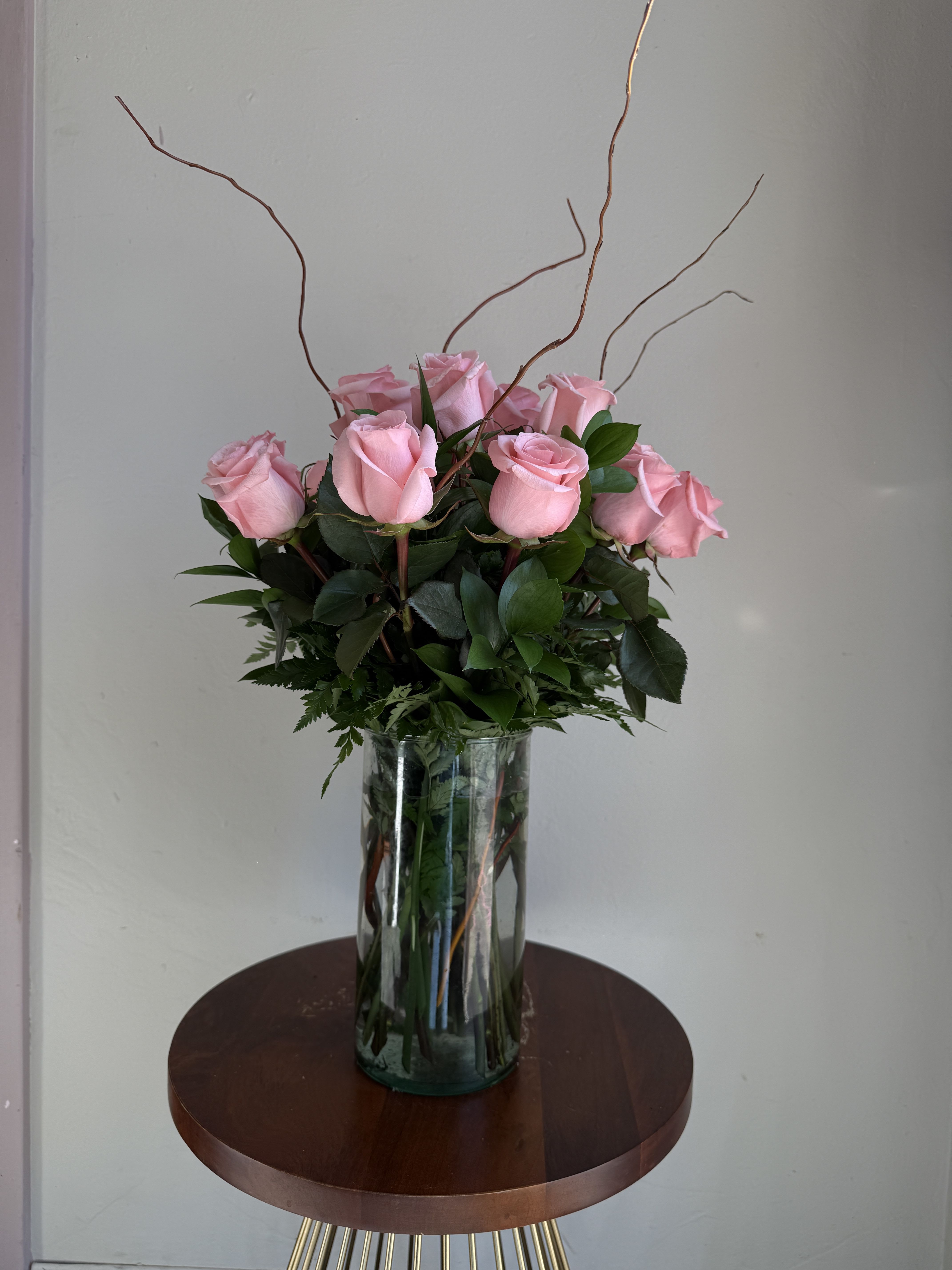 Be Sweet - Willow's Dozen - One Dozen Soft Pink Roses carefully arranged with greens and curly willow for a elegant romantic look.