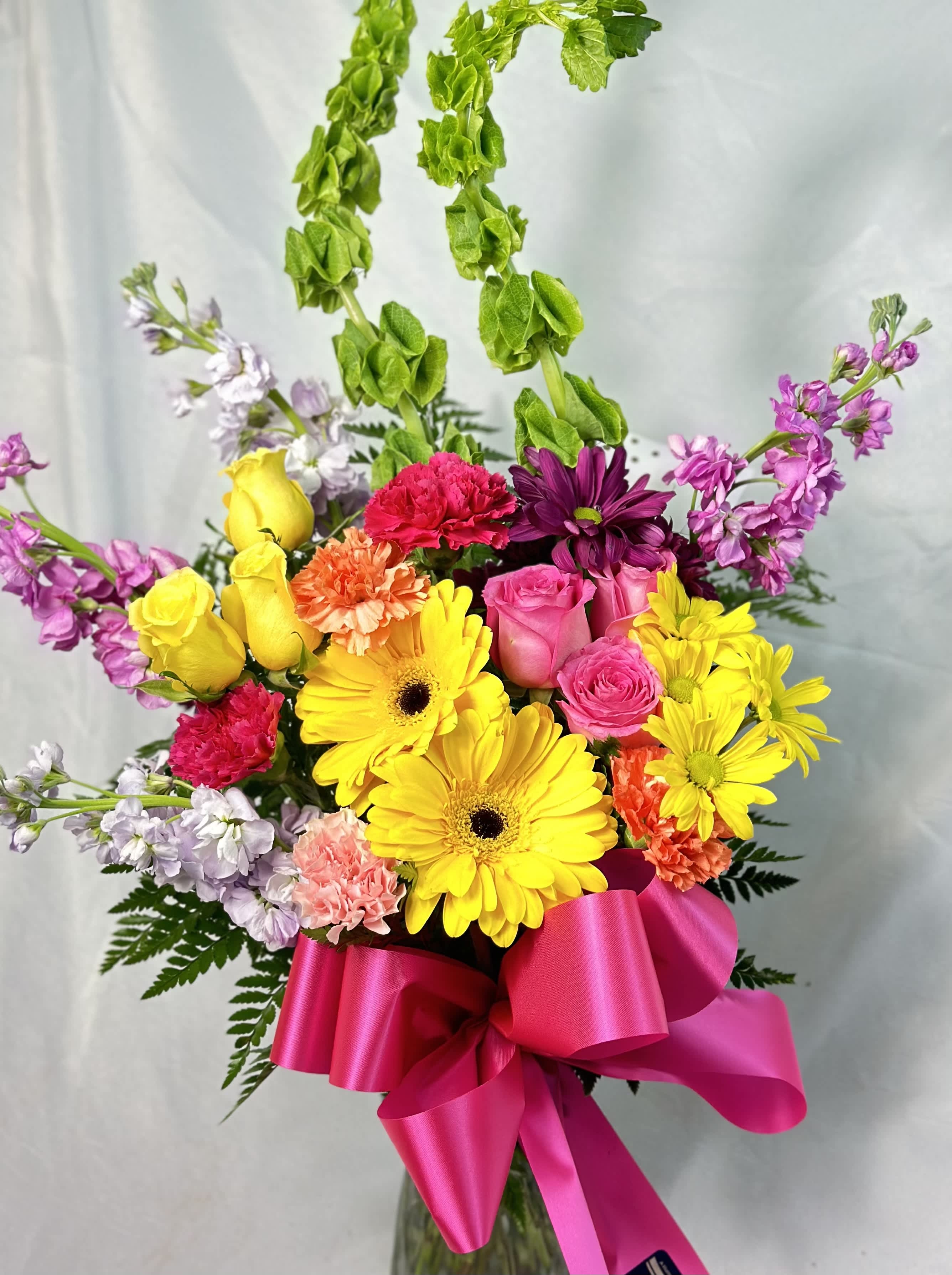 Oh, Happy Day - Make it a oh, so happy day with a large, bright, beautiful bouquet! Bright yellows, pinks with an accent or orange makes this a smile maker for sure! With bright Gerbera Daisies, Roses, Chrysanthemums, Daisies, Alstroemeria Stock, Larkspur and Bells of Ireland, this bouquet will win their heart! 