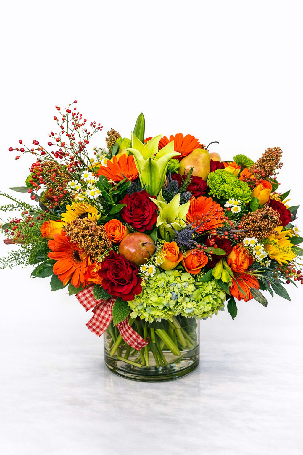 Autumn Harvest by Cactus Flowers - Autumn Harvest by Cactus Flowers is our signature celebration of fall — bold, abundant, and unforgettable.  Designed with rich burgundy roses, vibrant orange gerberas, golden roses, seasonal berries, lush greenery, and decorative harvest-inspired fruit accents, this piece captures the warmth and beauty of a Connecticut autumn in full bloom.  Each design is handcrafted in our Danbury studio with intentional texture, movement, and depth — because at Cactus Flowers, we don’t just arrange flowers… we create atmosphere.