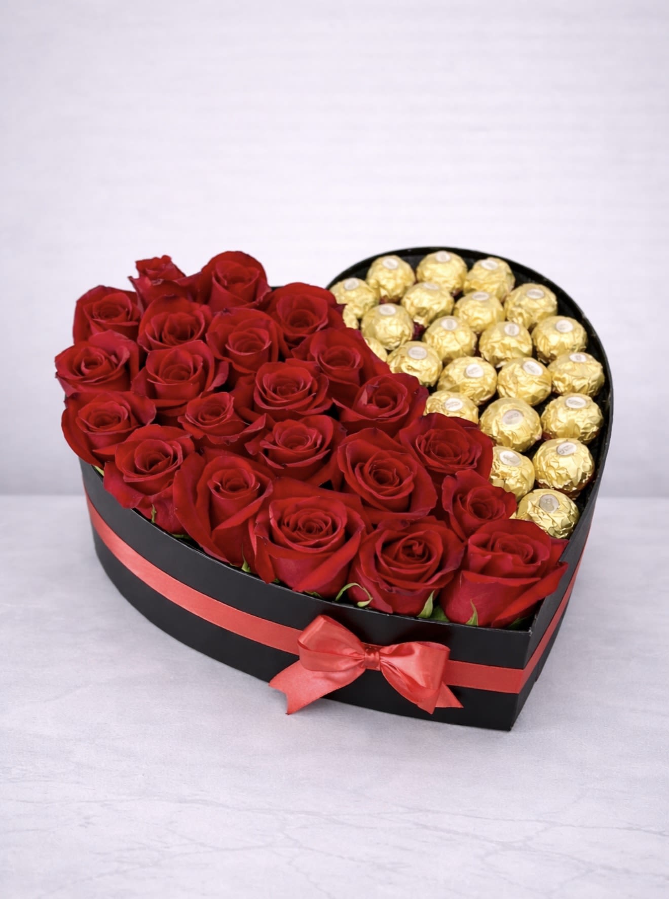 Golden Heart Romance Box – Red Roses &amp; Chocolate  - Sweep them off their feet with our Golden Heart Romance Box, a luxurious heart-shaped arrangement featuring fresh premium red roses paired with decadent Ferrero Rocher chocolates. Designed in an elegant black heart box with a satin red ribbon, this romantic gift is the perfect combination of flowers and sweets.  Ideal for anniversaries, Valentine’s Day, proposals, birthdays, or a surprise romantic gesture, this design makes a bold and unforgettable statement.  Handcrafted by AZ Flowers &amp; Gifts and available for same-day flower delivery in Alpharetta, GA 30022 and surrounding areas.  Order this red roses and chocolate heart box in Alpharetta today for a truly stunning romantic surprise. 