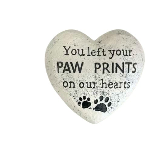  Paw Prints on Our Hearts Memorial Stone - Our Paw Prints on Our Hearts Memorial Stone is a touching tribute to the pets who left lasting love and joy in our lives. Crafted from weather-resistant resin with a natural stone finish, this heart-shaped keepsake features engraved paw prints and the heartfelt message, “You left your paw prints on our hearts.”  Perfect for garden memorials, pet gravesites, or indoor remembrance displays, this piece offers a comforting reminder of unconditional love that never fades.   Details: 	•	Measures approximately 6” wide 	•	Durable, outdoor-safe resin 	•	Subtle hand-finished texture for a natural stone look 	•	Suitable for dog or cat memorials 	•	Arrives beautifully packaged and ready for gifting
