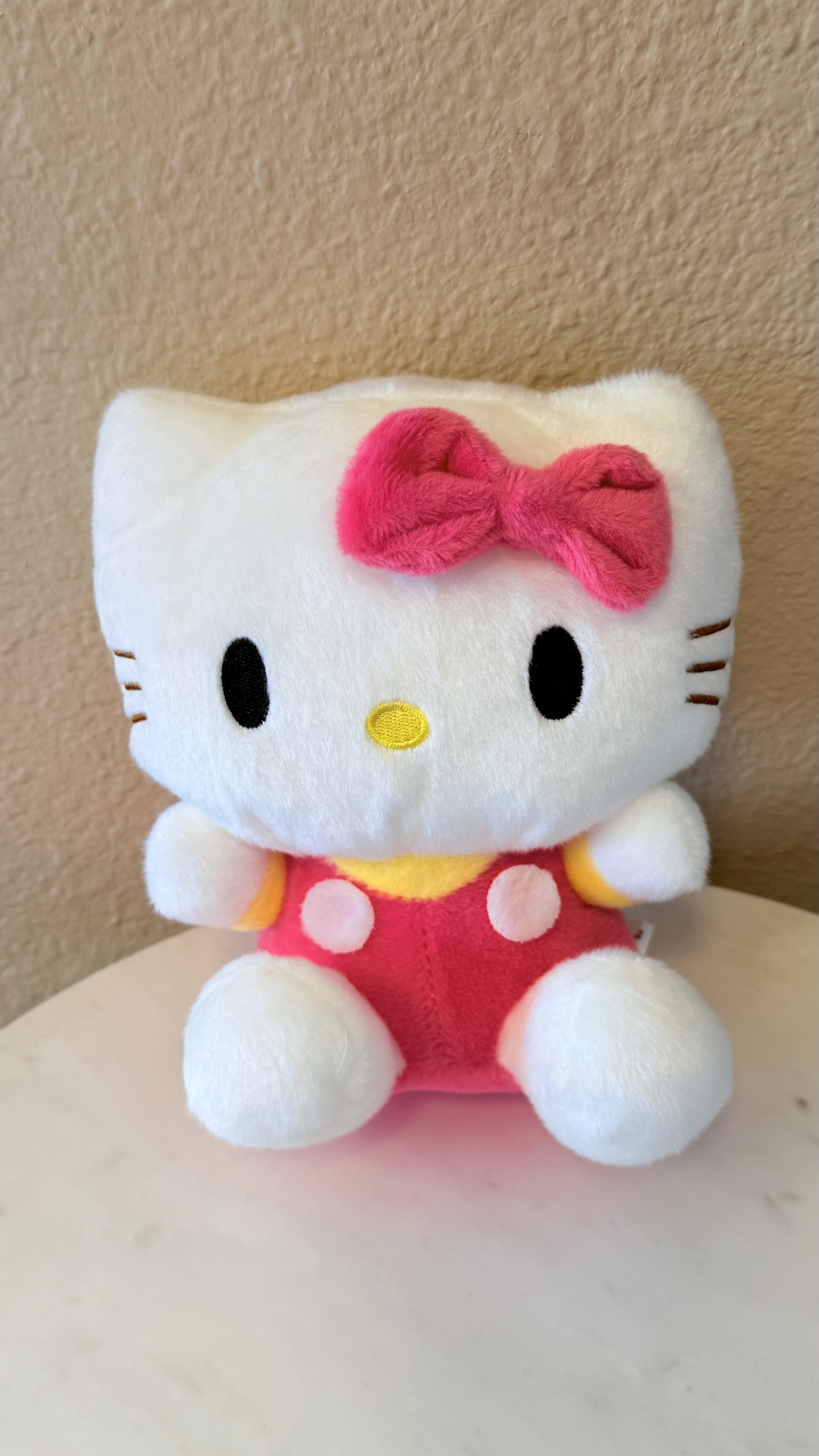 Hello Kitty® Sweet Hug Plush - Soft, sweet, and irresistibly cuddly  This classic Hello Kitty plush features her signature pink bow and cozy pastel outfit, making it the perfect add-on for flowers, gift baskets, or a heartfelt surprise. A timeless symbol of friendship and love—ideal for birthdays, Valentine’s Day, baby showers, or just because. This plush brings comfort, charm, and a smile at first hug.