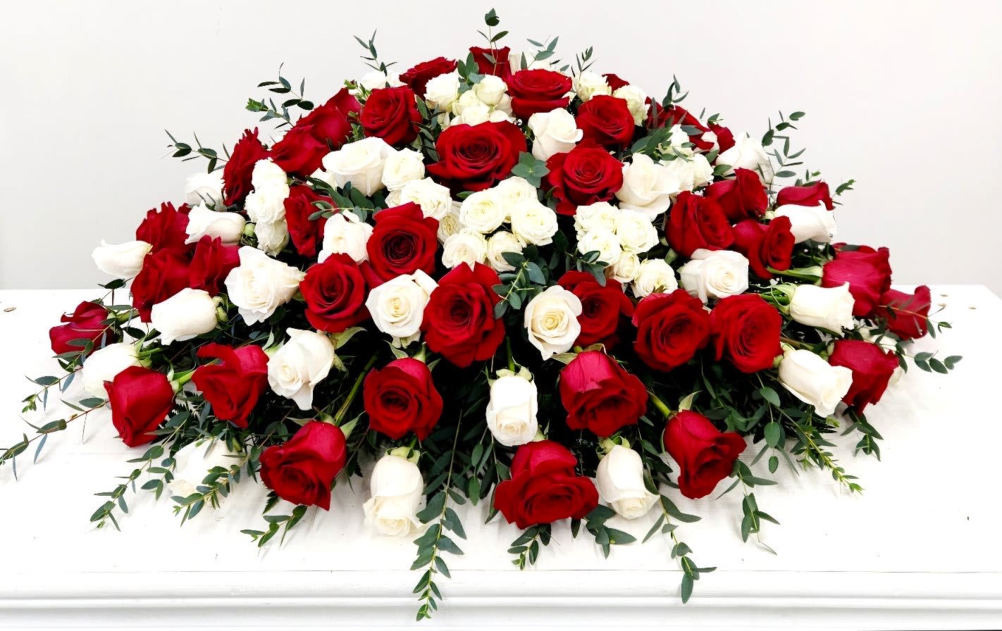 Peaceful Rest Casket Spray - The Peaceful Rest Casket Spray offers a graceful tribute, capturing the essence of a life well-lived. Carefully crafted with red and white roses, this arrangement provides a comforting and loving farewell, honoring cherished memories with elegance and respect. Its serene beauty offers solace and a gentle reminder of lasting peace Premium - As Pictured: "52 L X 34" D 