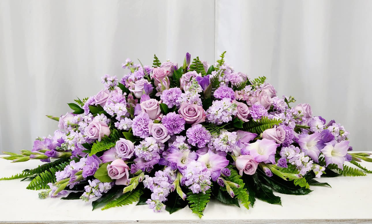 Loving Recollection Casket Spray - The Loving Recollection Casket Spray offers a gentle and elegant tribute, beautifully crafted to honor cherished memories. Its luxurious blend of fresh blooms creates a serene and comforting presence, providing heartfelt support during difficult times. This exquisite arrangement serves as a meaningful expression of love and remembrance, bringing grace and tranquility to any memorial. As Pictured: "52" X 32"D 