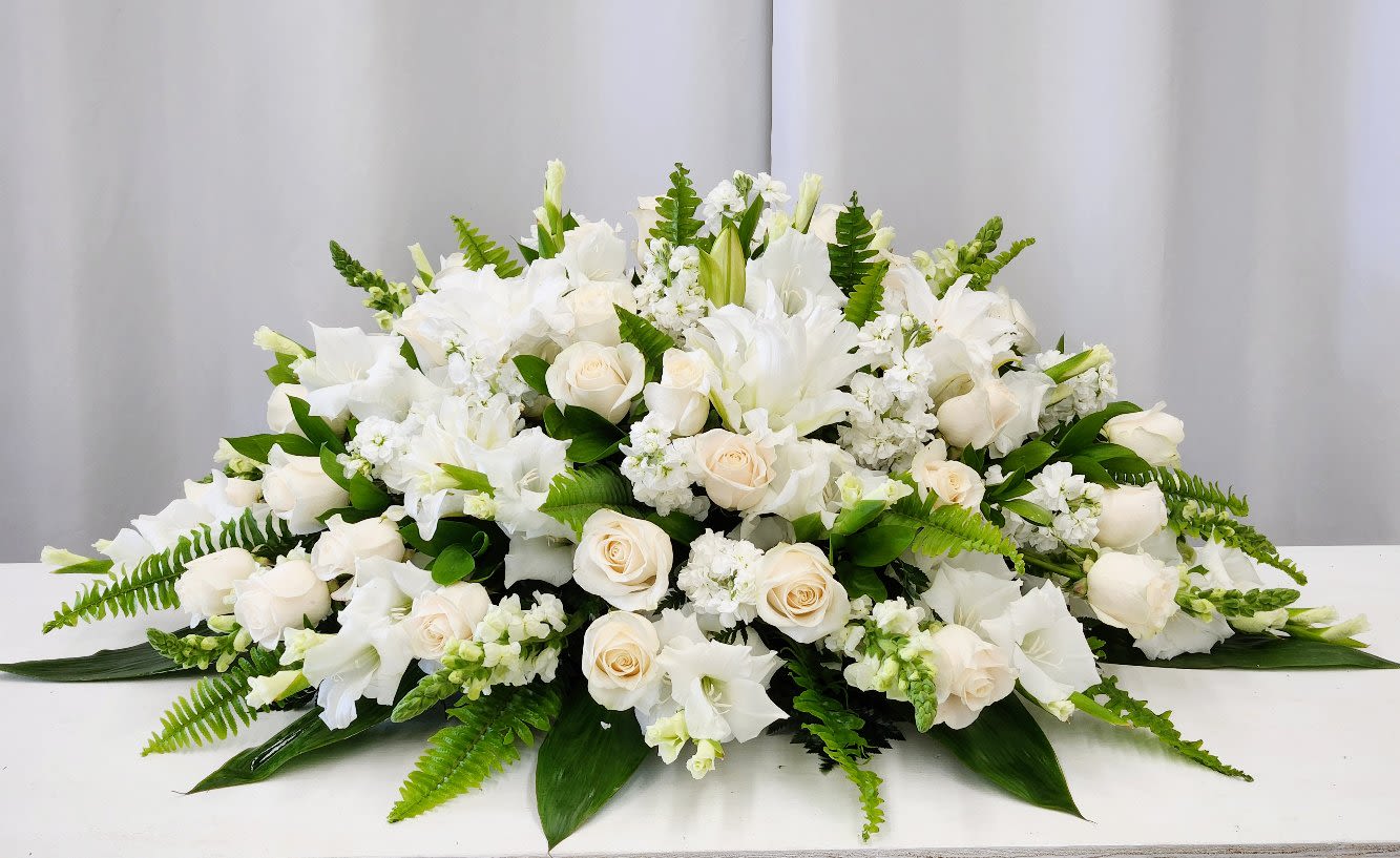 Heaven Sent Casket Spray - The Heaven Sent Casket Spray offers an elegant and luxurious tribute that embodies classical beauty and timeless grace. Thoughtfully designed to honor cherished memories, its refined arrangement provides a heartfelt expression of love and respect. This distinguished spray serves as a meaningful and lasting farewell, bringing comfort and serenity during difficult time.. AS SHOWN: Premium - As Pictured: 50" L X 34" D