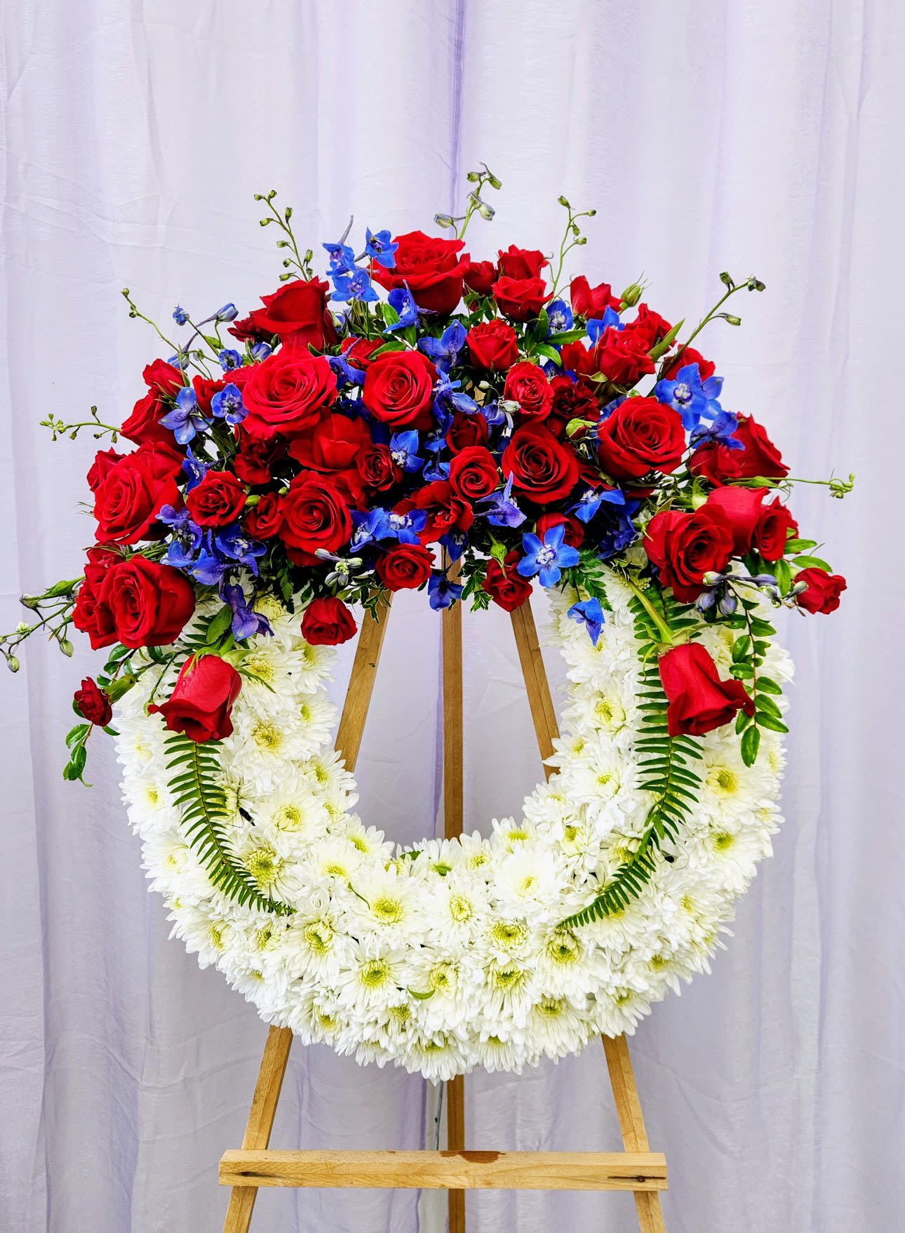 The Honor Wreath - The Honor Wreath embodies patriotic strength and timeless beauty, perfect for showing respect and remembrance. Crafted to symbolize honor, this wreath serves as a meaningful tribute that reflects dignity and gratitude. Its elegant design brings a sense of solemn strength to any space, making it a heartfelt way to commemorate and support those who have served.  Standard: 18"  Deluxe: 24"  Premium - As Pictured (As Pictured): 30"