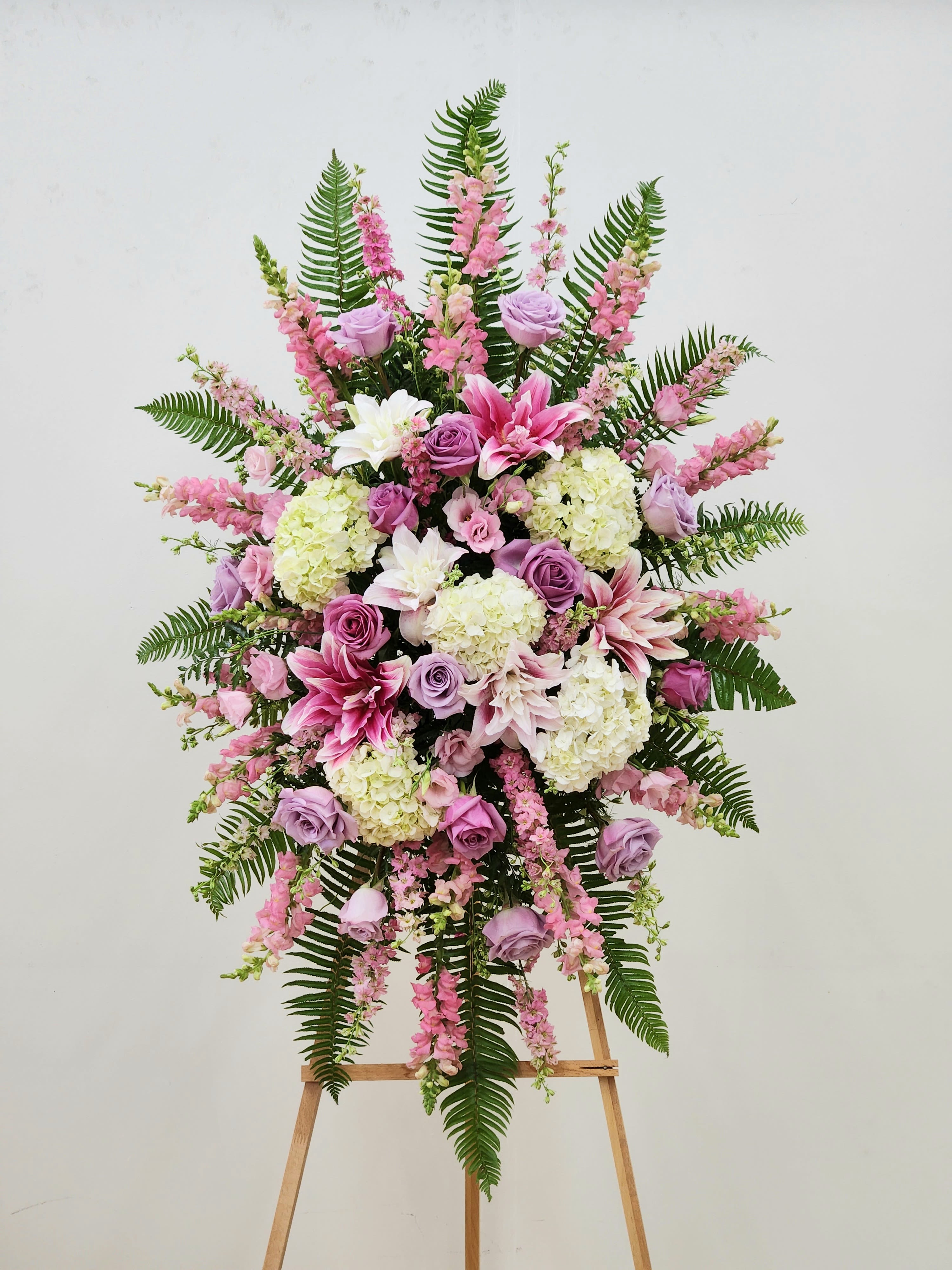 Garden Of Memories - The Garden of Memories memorial piece offers a serene tribute to deep love and heartfelt sympathy. Designed to bring calm and healing, it serves as a gentle reminder of cherished moments and enduring bonds, providing comfort during times of remembrance.  Approximate Size Without Stand: 32" Wide by 46" Tall  ONE SIZE ONLY