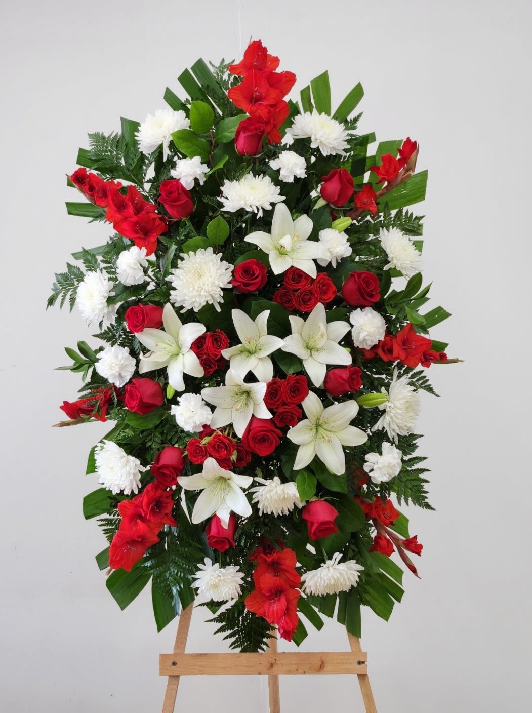 Warmest Embrace Spray - The Warmest Embrace Spray offers a gentle, heartfelt way to honor and remember your loved ones. Designed to convey comfort and lasting affection, this spray helps express sincere sympathy and support during difficult times. Its thoughtful presence serves as a tender reminder that those we cherish remain close in memory and spirit.  Approximate Size Without Stand:  Standard: 20" x 24"  Deluxe: 25" x 30"  Premium - As Pictured: 32" x 42"