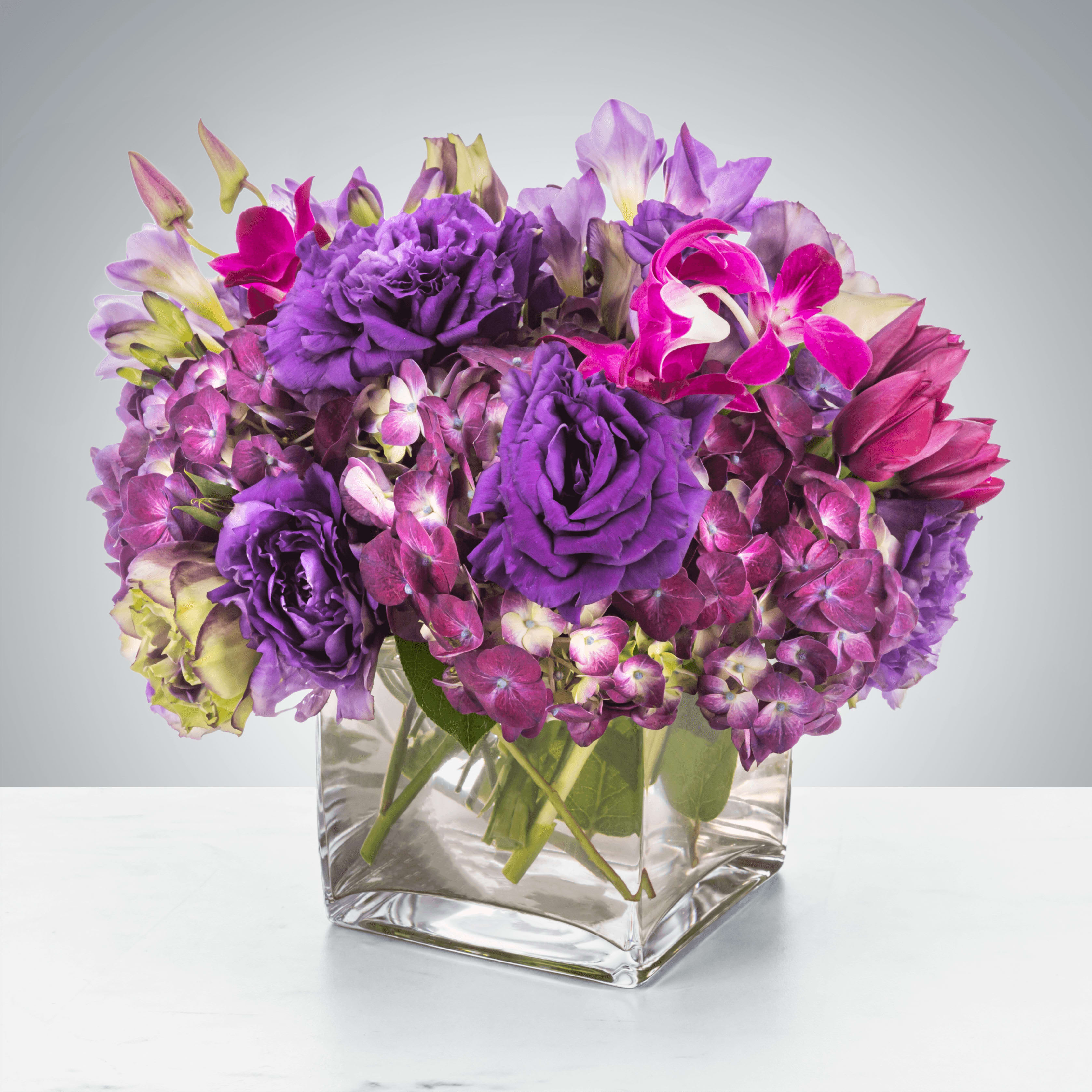 Royalty  - This monochromatic purple arrangement is perfect for any event ranging from a housewarming gift to a friend to a birthday surprise! Send it to somebody who deserves to be treated royally.  Approximate Dimensions: 10"D x 10"H