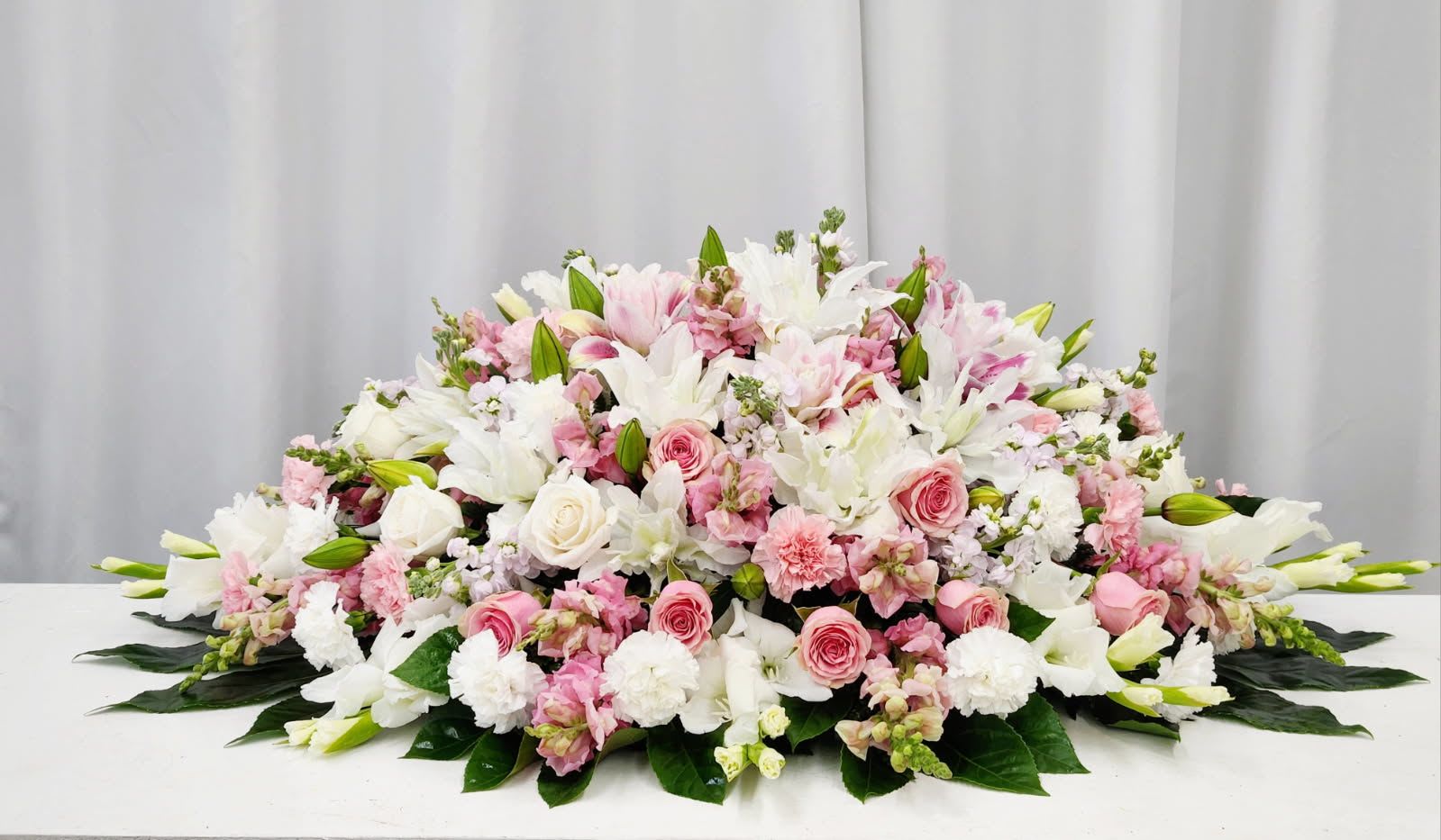 Gentle Soul Casket Spray - Shipping calculated at checkout. The Gentle Soul Casket Spray honors a beautiful, kind, and gentle spirit with its elegant design. Thoughtfully crafted to convey heartfelt sympathy, this arrangement provides a graceful tribute that reflects warmth and tenderness, offering comfort and peace. Premium - As Pictured: "56L X 30"D