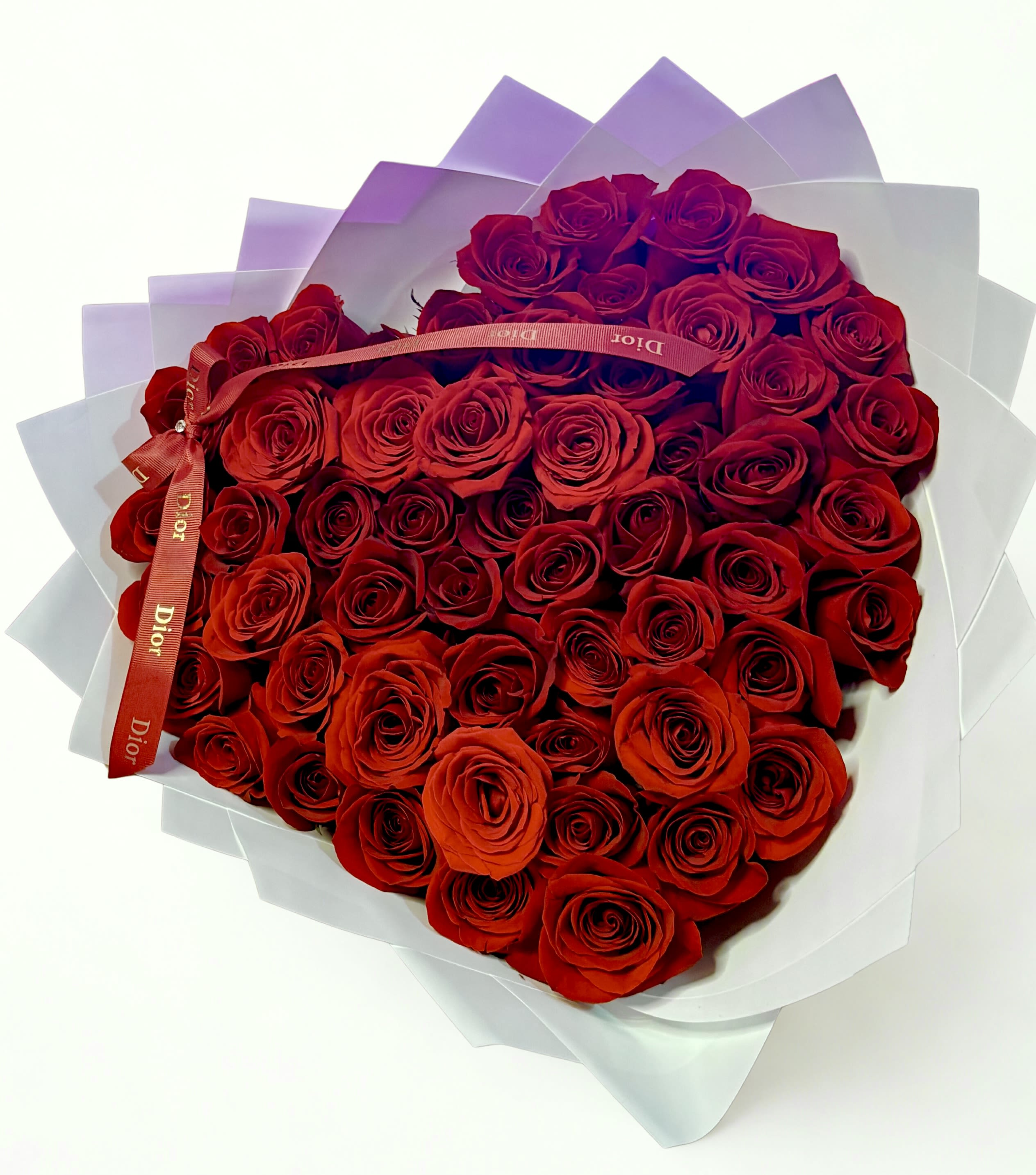 The Dior Rose Heart Bouquet - Surprise your loved one with our stunning Heart Bouquet.  This luxurious arrangement features 50 premium red roses, carefully designed in a romantic heart shape — a timeless symbol of love, passion, and elegance.  Perfect for anniversaries, birthdays, proposals, or simply to say I love you in the most unforgettable way.   Wrapped in elegant paper and finished with a luxury ribbon.  Limited quantity available. Pre-order required for pickup or delivery.