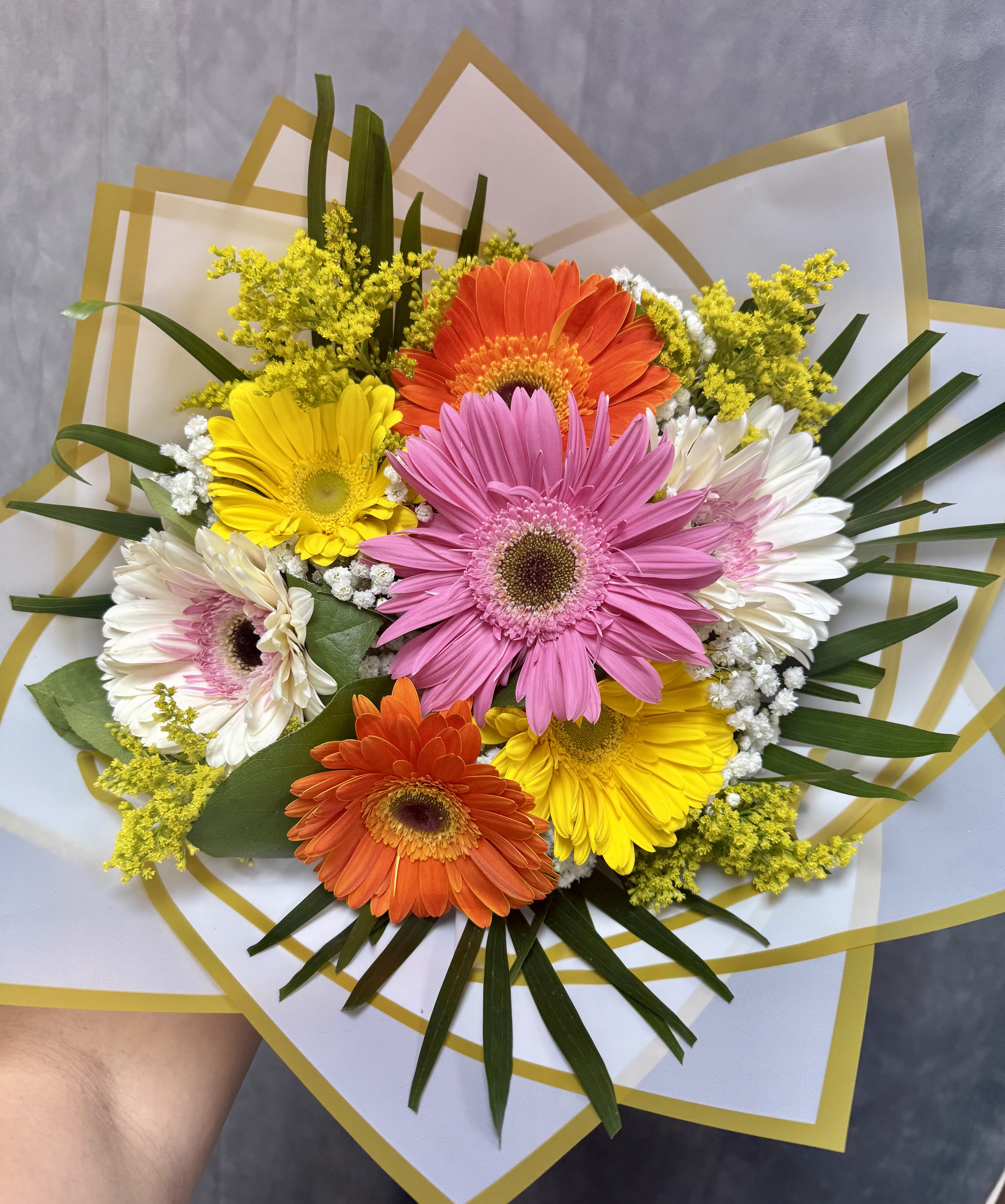 Gerbera Daisies Lovers Bouquet  - A cheerful mix of vibrant gerbera daisies, accented with baby’s breath, solidago, and fresh greenery. Designed as a handtied wrapped bouquet and finished with a soft ribbon, this bright arrangement is perfect for birthdays, get well, thank you, or just because.  Handcrafted with love at J&amp;S Floral 