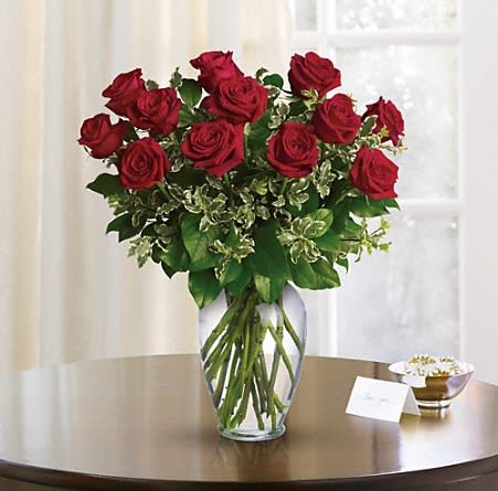 Always On My Mind - Premium Red Roses with assorted greens arranged in a glass vase. Red rose resembles love.