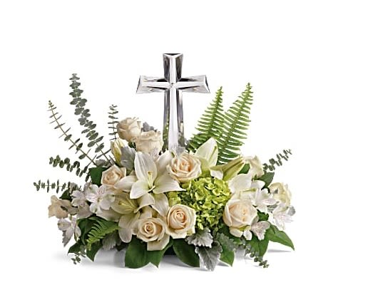 White floral arrangement with a silver cross centerpiece