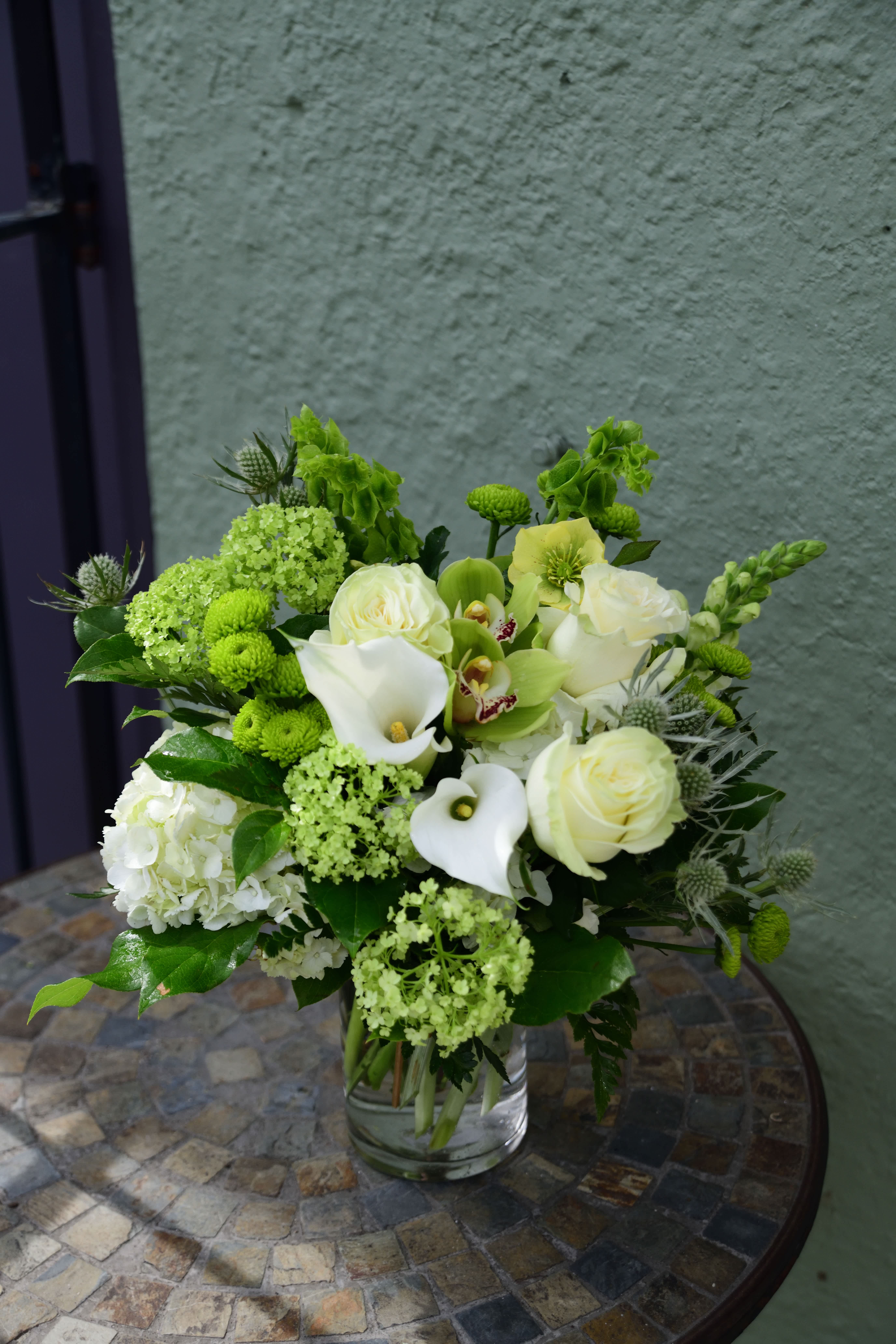Danny Boy - "Oh, Danny Boy!" Celebrate the Irish spirit with this beautiful green and white design, featuring calla lilies, viburnum, hydrangea, cymbidium orchids, roses, and more! Limited time offer.