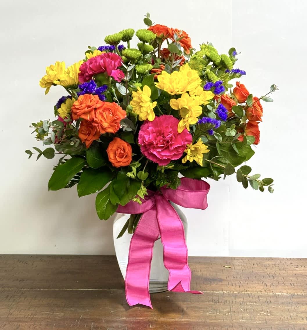 Brighten Up Their Day Bouquet - A beautiful arrangement with a mix of bright colors. Arrangement might vary a bit on types of flowers but overall feel and size will stay the same. 