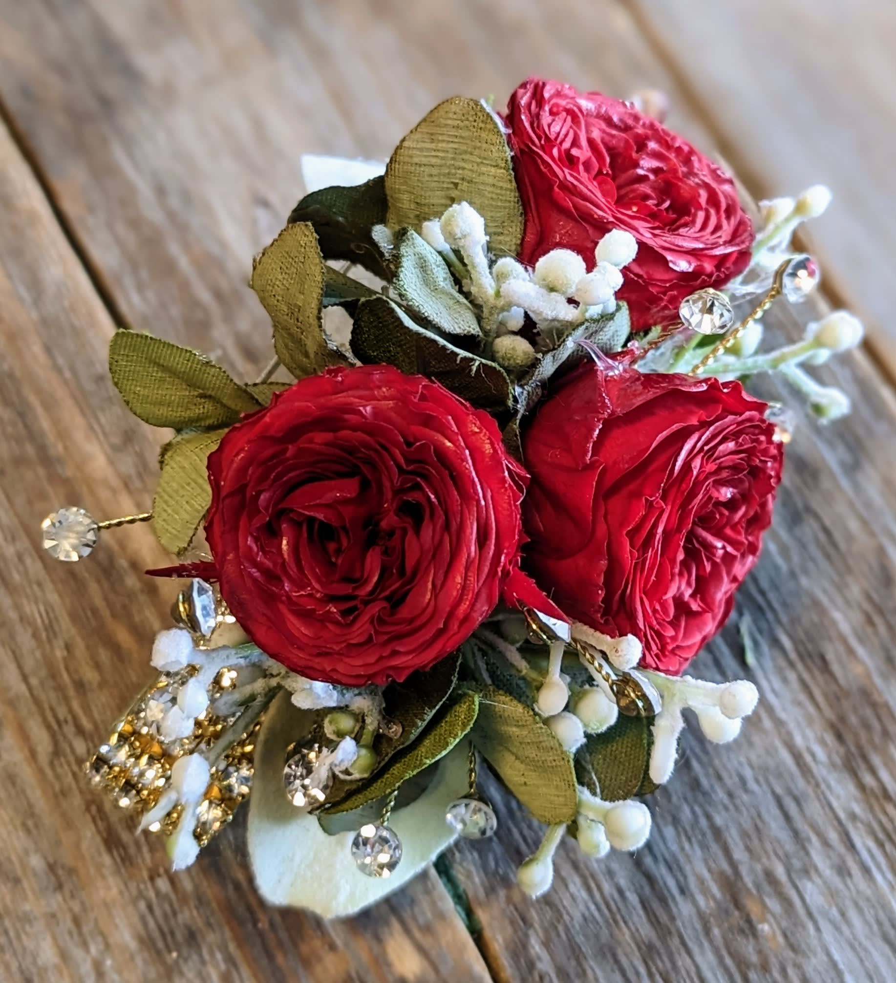 Red Preserved Rose Corsage On A Rhinestone Bracelet - Red preserved roses with rhinestone sprays on a rhinestone bracelet. Please note these are not fresh flowers.