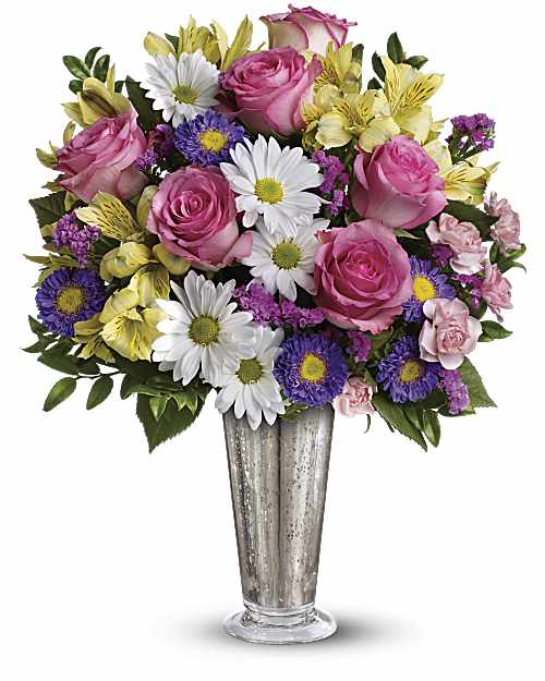 Pink roses and mixed daisies in a tall silver vase