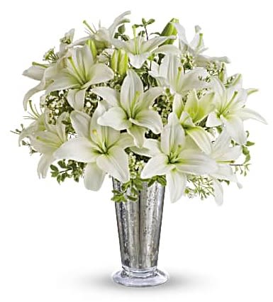 Written in the Stars - She may say "You shouldn't have" when she sees this breathtaking bouquet.  But she won't mean it. She'll adore the fragrant white asiatic lilies and waxflower showcased in a mercury class antique vase she'll cherish forever.  Yes, you definitely should. Striking white asiatic lilies and delicate white waxflowers. Hand-arranged in an eye-catching Mercury Glass Antique vase. Orientation: All-Around  SUBSTITUTION POLICY – Please note the bouquet pictured reflects our original design.  If the exact flowers or container in this arrangement are not available, our local florists will create a beautiful bouquet with the freshest available flowers. 