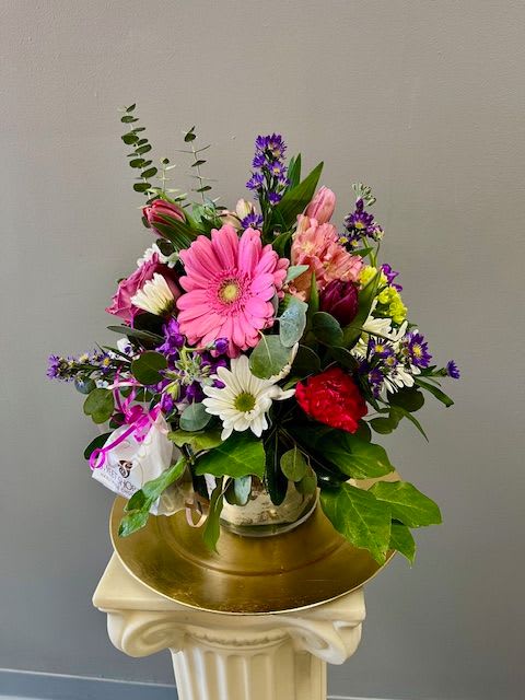 Sweet Treat - Sweet Treat is the best of both worlds...flowers &amp; candy! We start with a beautiful arrangement of mixed Spring colored flowers and then we attach a bag of two Sweet Shop Truffles into the design. The recipient will love having flowers and a Sweet Treat!