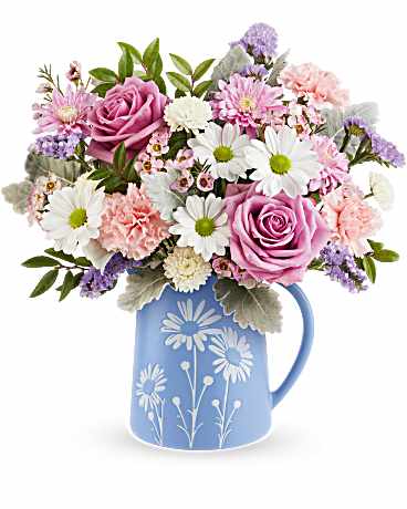 Teleflora's Pastel Meadow Bouquet - Soft and serene, Teleflora's Pastel Meadow Bouquet brings the beauty of a blossoming garden indoors with delicate lavender roses and pastel blooms arranged in a blue food-safe pitcher featuring a charming white daisy design. 