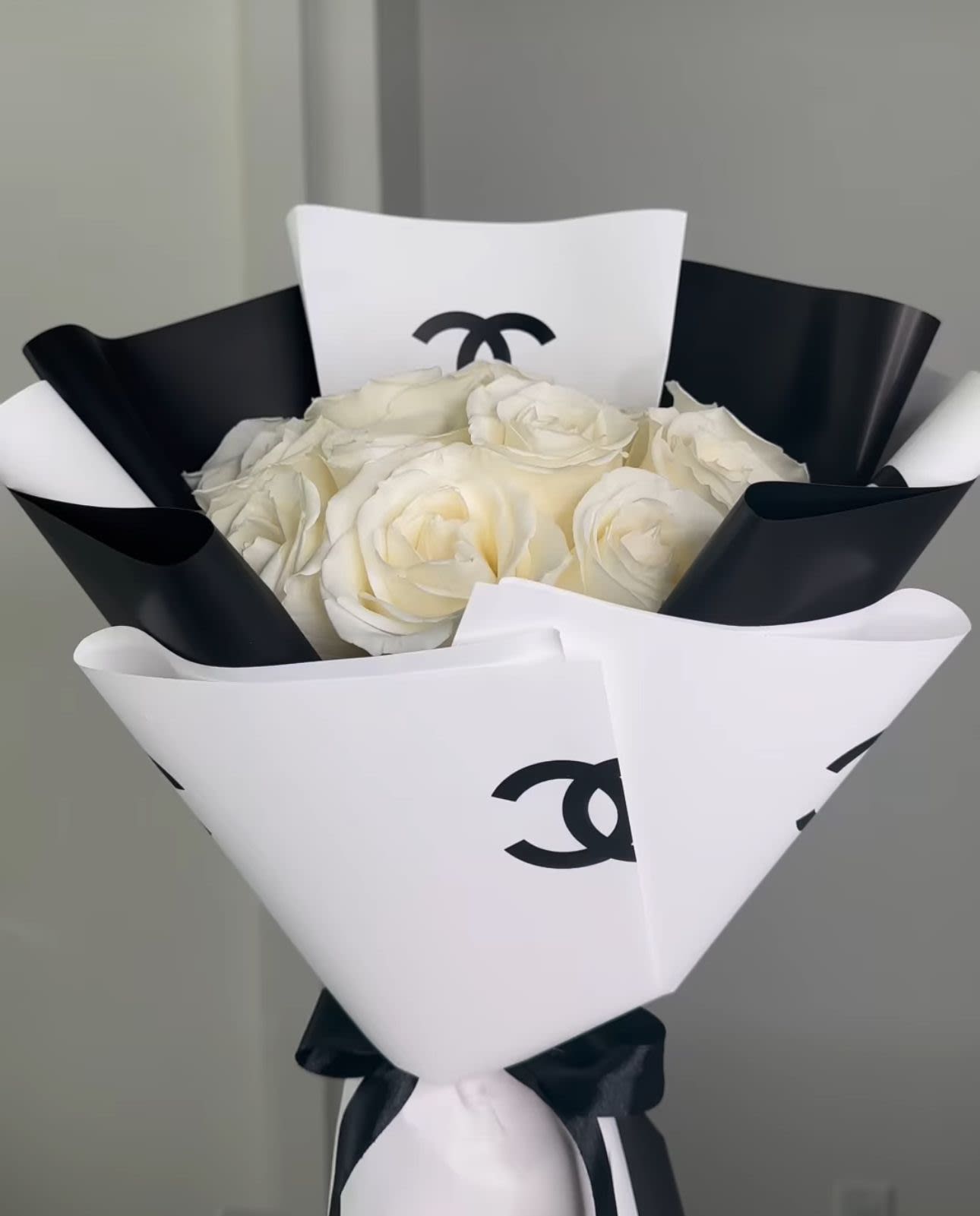 CC White arrangement - For classic romance two dozen white roses is always the perfect choice. 1 to 3 dozen long-stemmed white roses in a Channel paper wrap