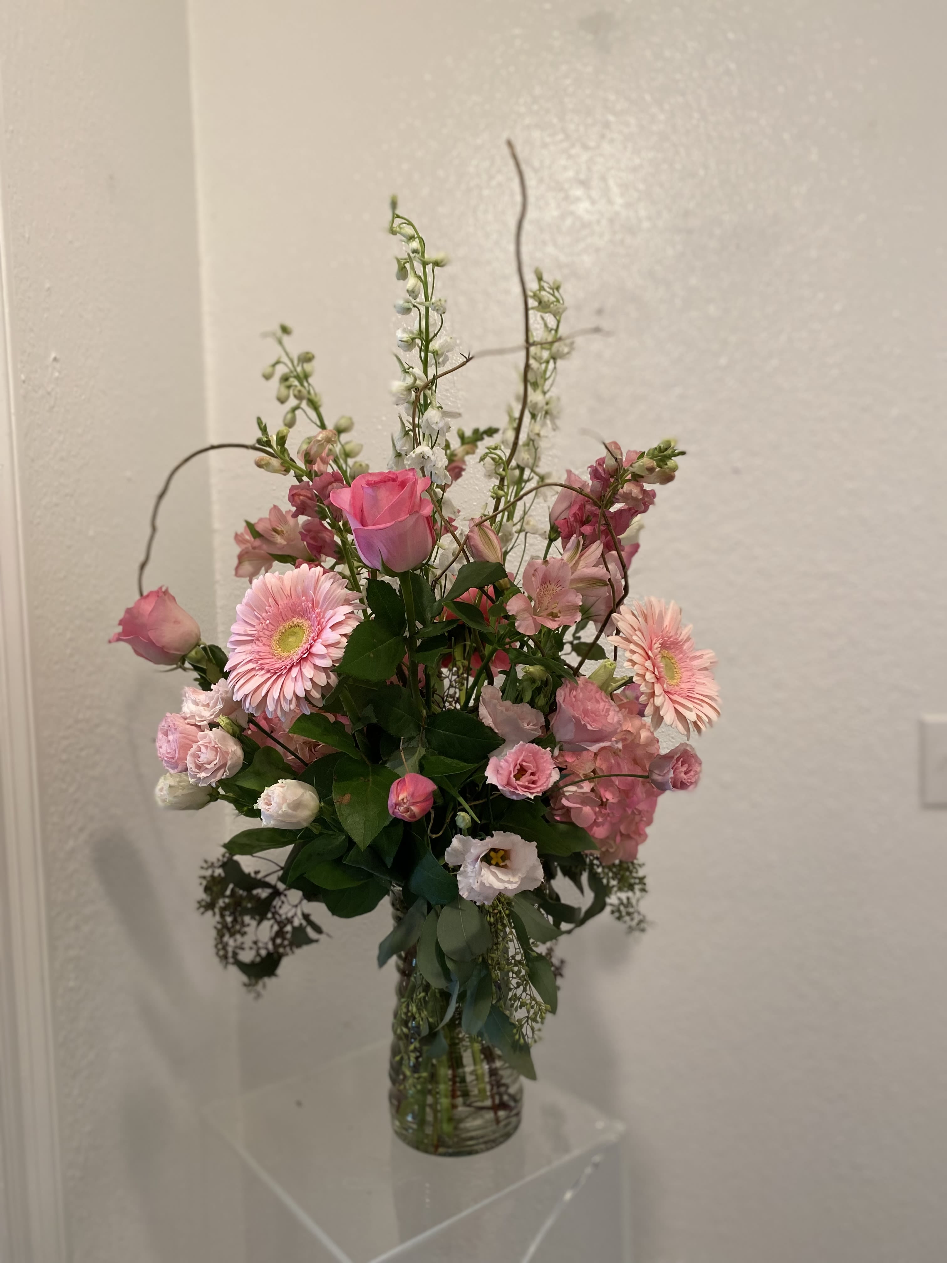 Pink mixed flower arrangement in a clear glass vase