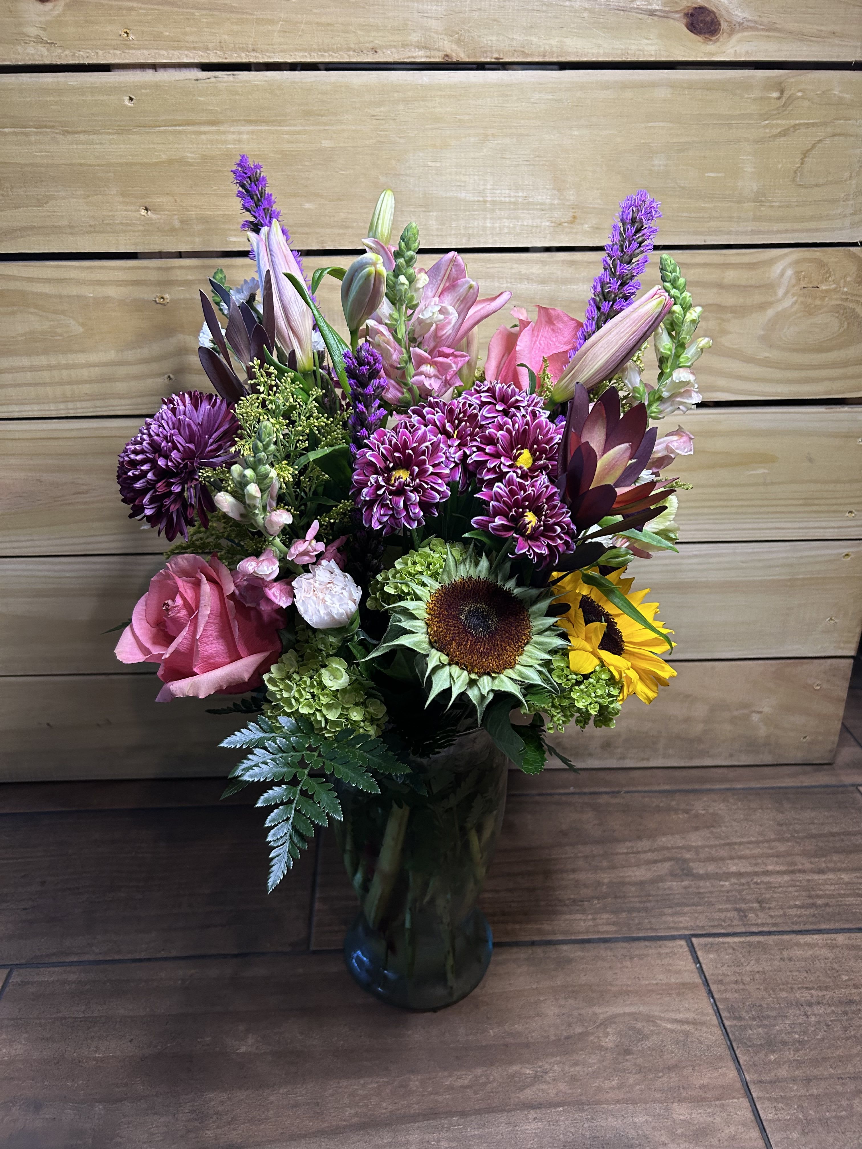 Garden Daydream - Step into a dream garden with a beautiful mix of sunflowers, roses, hydrangeas, liatris, and solidago. 