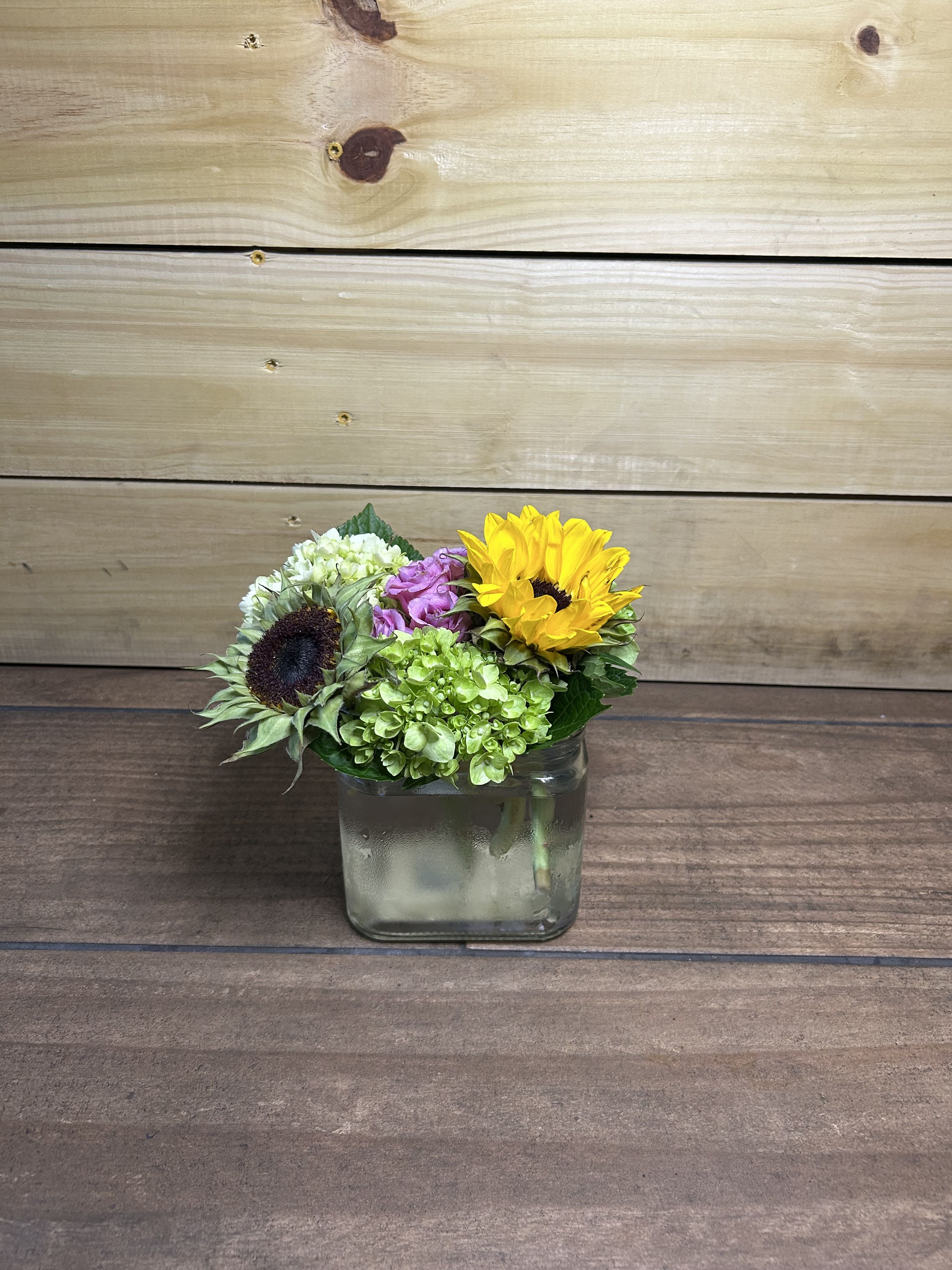 Petal Poetry - A mix of sunflowers, hydrangeas, and spray roses.
