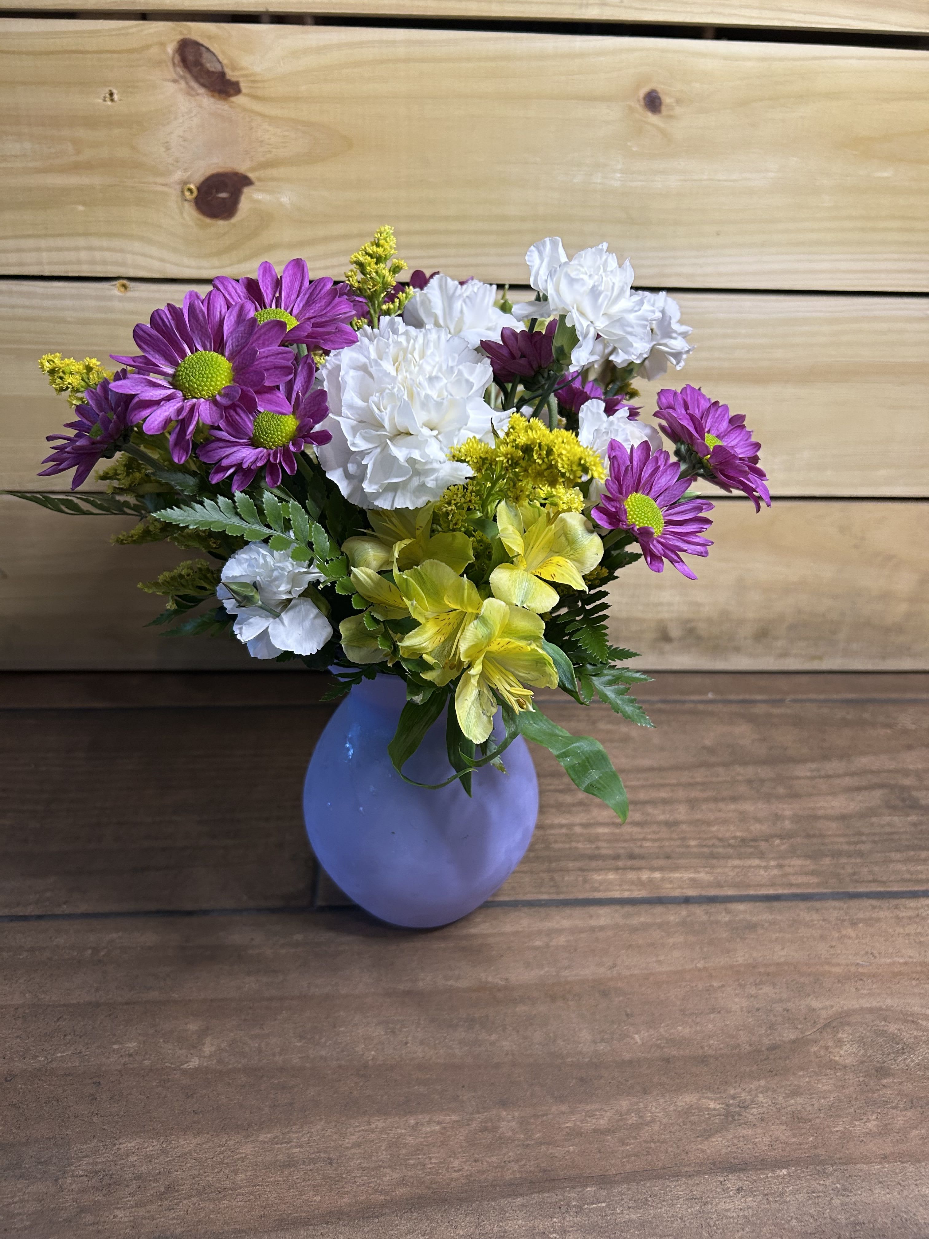 Simply Smitten - A mix of carnations, daises, and alstroemeria in a simple purple vase. 