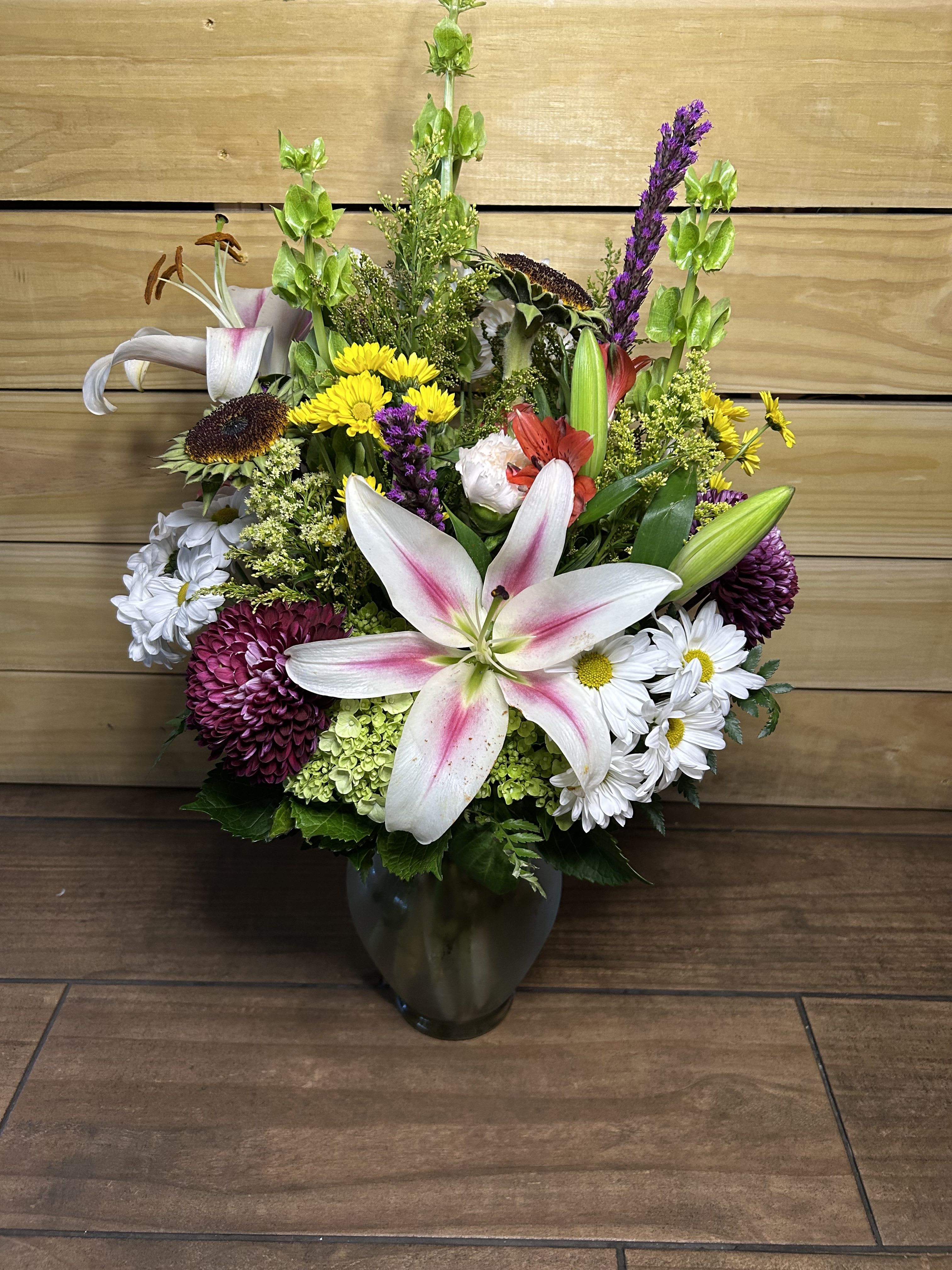 Wildflower symphony - A beautiful mix of bold florals, full of texture, with a lily front and center