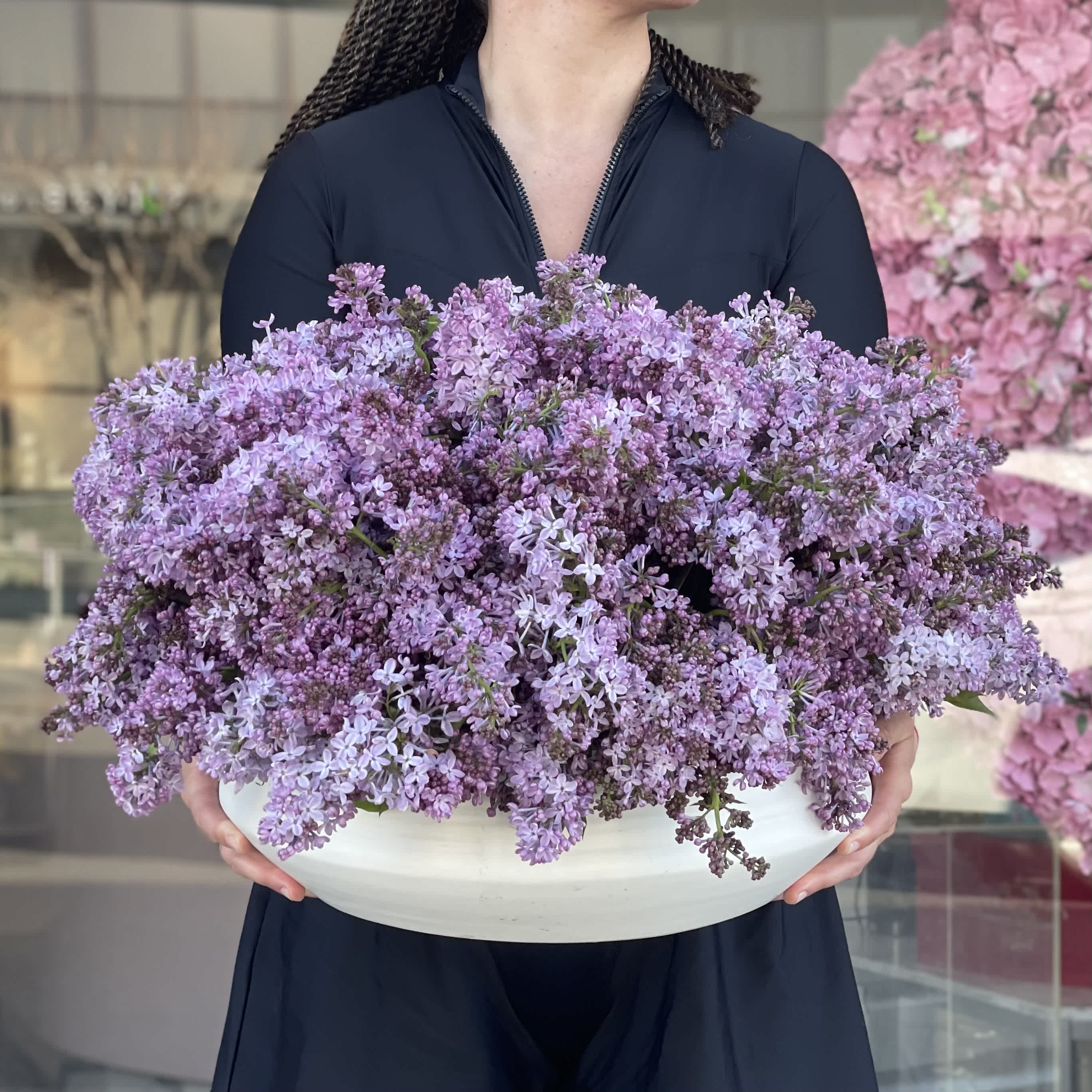 Lilac Bliss V - Crafted to elevate any space, this arrangement exudes a subtle yet captivating charm, perfect for adding a touch of sophistication to your home or when gifting to someone special. Whether adorning a dining table, brightening a workspace, or serving as a heartfelt gesture, the Lilac Bliss arrangement in the Vase is sure to leave a lasting impression.