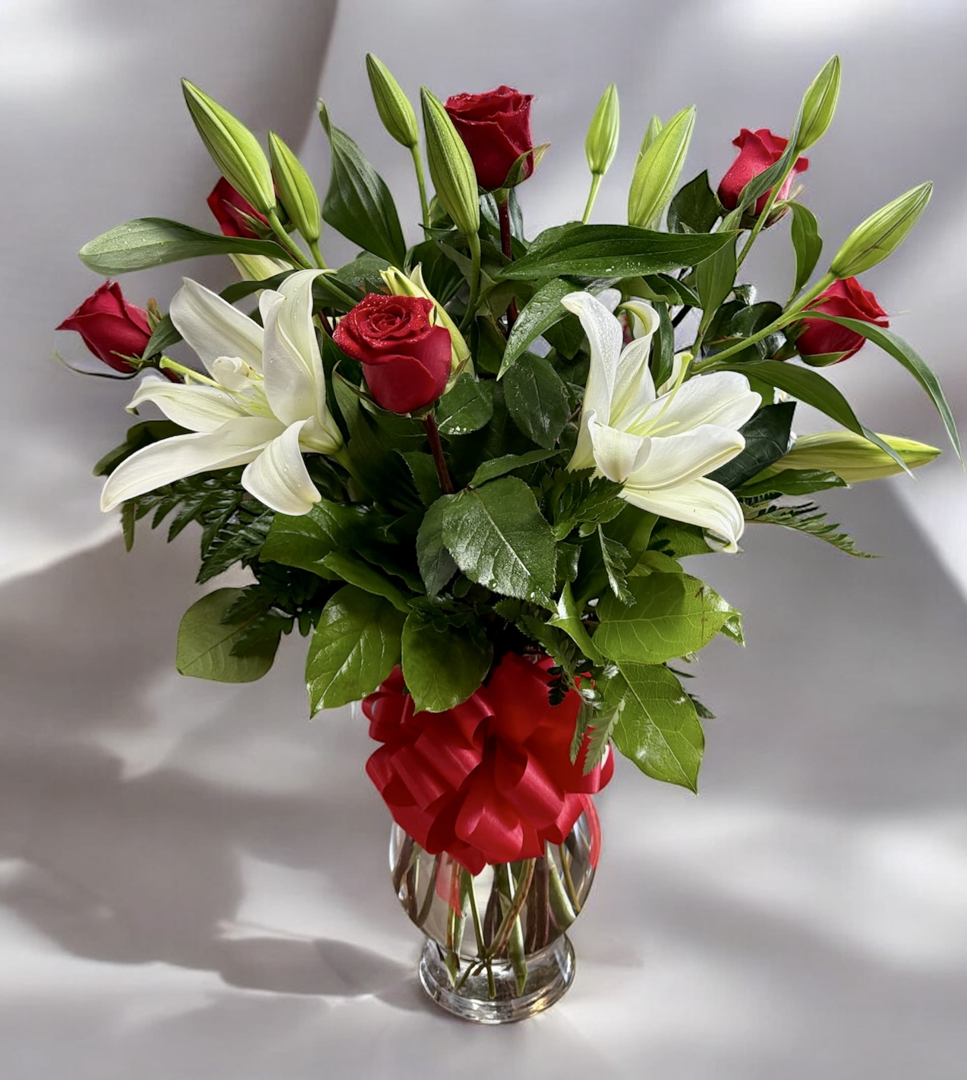 Lily and Rose - Lilies and roses in clear vase with  bow