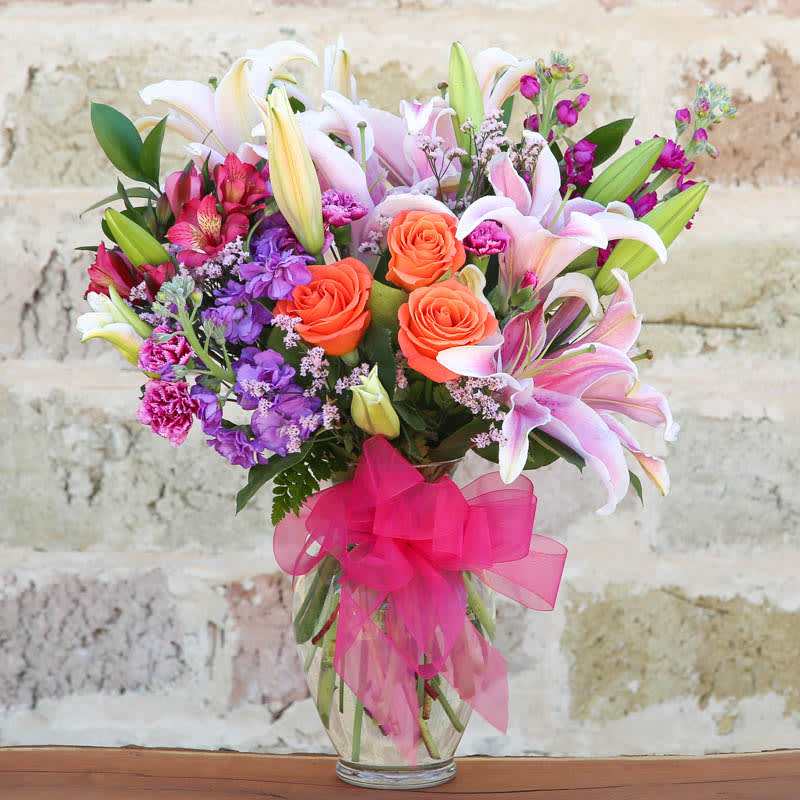 Pretty and perfection - SHOW HER SHE'S #1 WITH THIS BEAUTIFUL ARRANGEMENT OF PINK OR WHITE LILIES, STOCK AND CORAL ROSES. FRESH FLOWERS ARE A GREAT WAY TO SHOW THAT YOU APPRECIATE ALL SHE DOES.