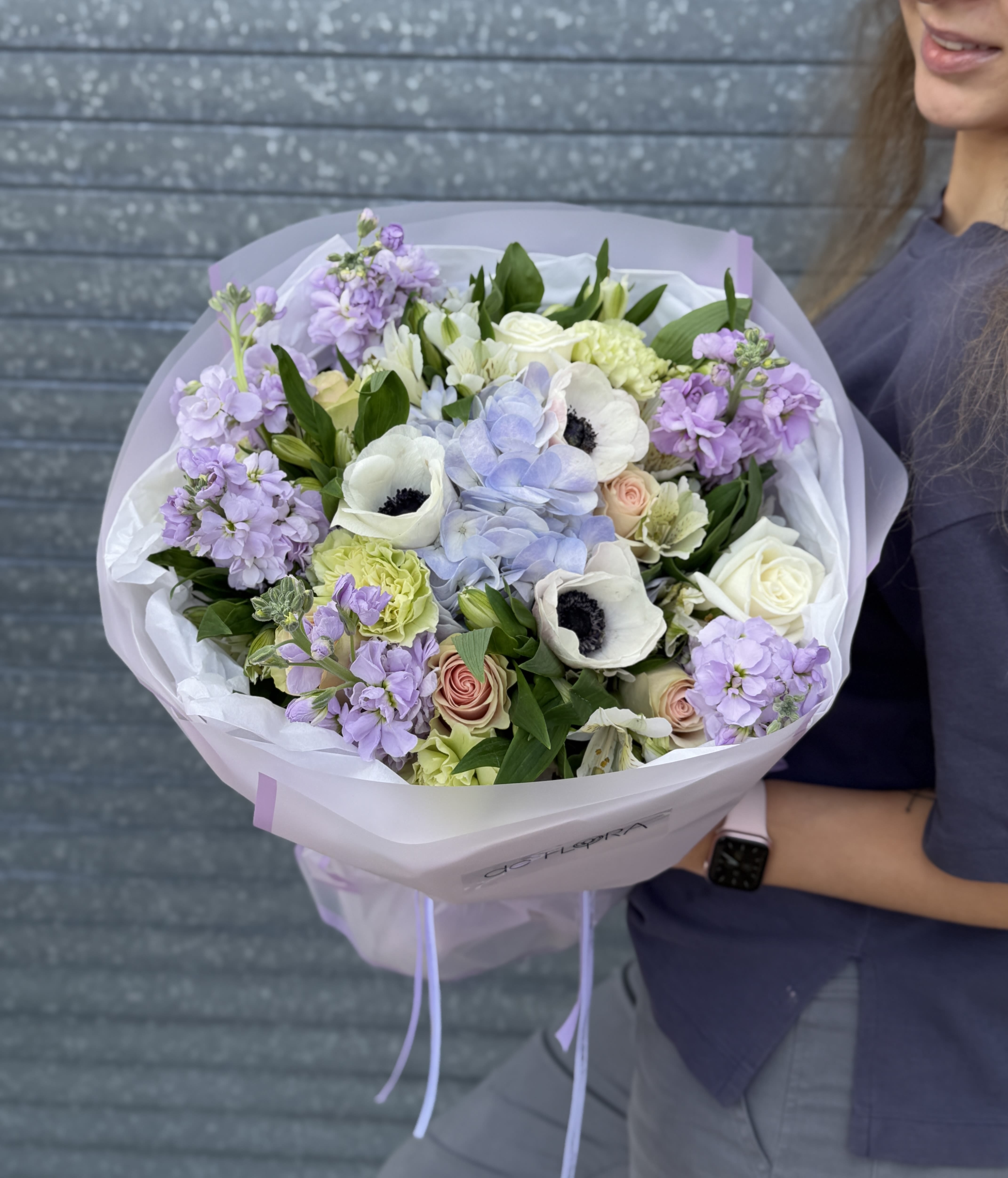 Amour Pastel - Inspired by soft coastal light and refined femininity, this bouquet combines hydrangea clouds, creamy roses, fresh greenery, and romantic lilac blooms.  It feels airy, fresh, and effortlessly chic — perfect for a confident woman with graceful taste.