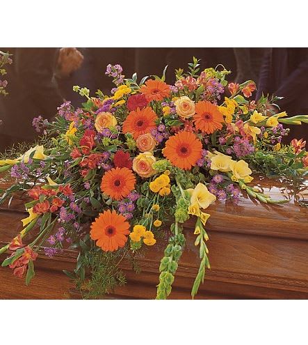TF203-2 Summer Sentiments Cskt Spry - Express your warmest sentiments with this colorful spray of summer's brightest blooms. Each casket spray is decorated with red carnations, yellow gladioli, orange gerberas, purple Monte Cassino asters and roses with soft foliages. Approximately 51" W x 38" H 