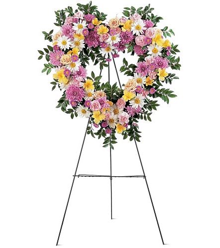 TF199-4 Loving Heart Tribute - This lovely heart-shaped design will leave no doubt just how much love you want to show family and loved ones. Each spray is created with lavender chrysanthemums, white daisies, yellow alstroemeria, pink asters and spray roses, delivered on an easel. Approximately 22" W x 22" H 