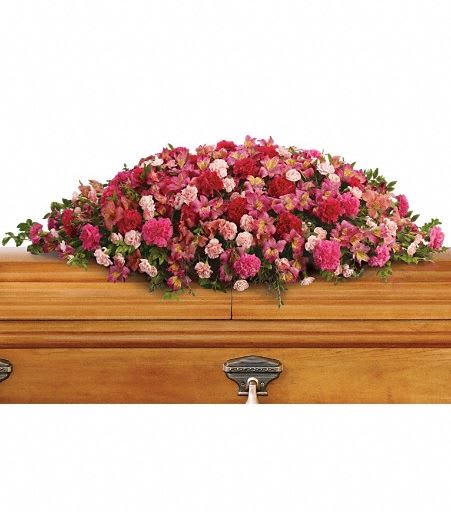 T259-3A A Life Loved Casket Spray - As a tribute to a special person who has passed, this magnificent cascade of pink floral favorites is a radiant testament of profound and lasting love. The sumptuous bouquet includes dark pink alstroemeria, hot pink carnations, pink carnations and miniature light pink carnations accented with huckleberry and eucalyptus. Approximately 49" W x 19" H 