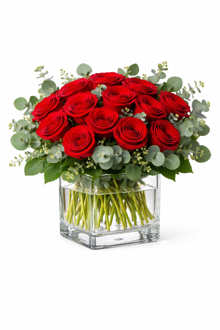1 Dozen Rose Cube  - A classic clear glass cube with 12 fresh red roses and  greenery  *Vase/container may vary depending on availability of stock at time of purchase. *We strive to use the flowers shown whenever possible; however, substitutions of equal or greater value may be made based on seasonal and market availability. 